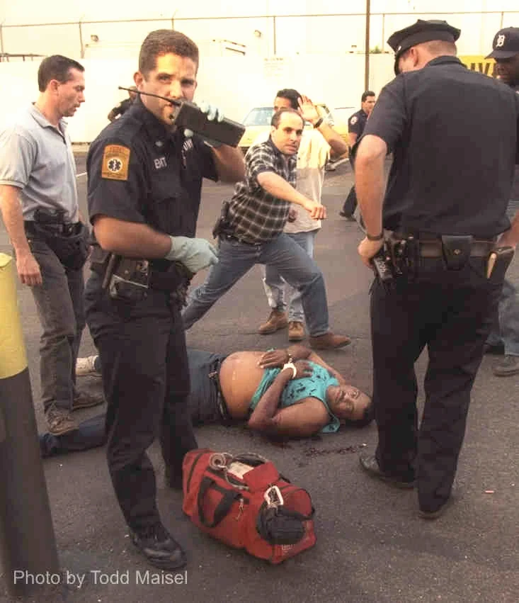 Cop shot at McDonald's on 10th Avenue and West 34th Street in Federal Drug Sting. In this picture however, the suspect in the drug sting was shot by DEA cops and breathes his last breath as he lay dying from his gunshot wound August 6, 1997. By Todd