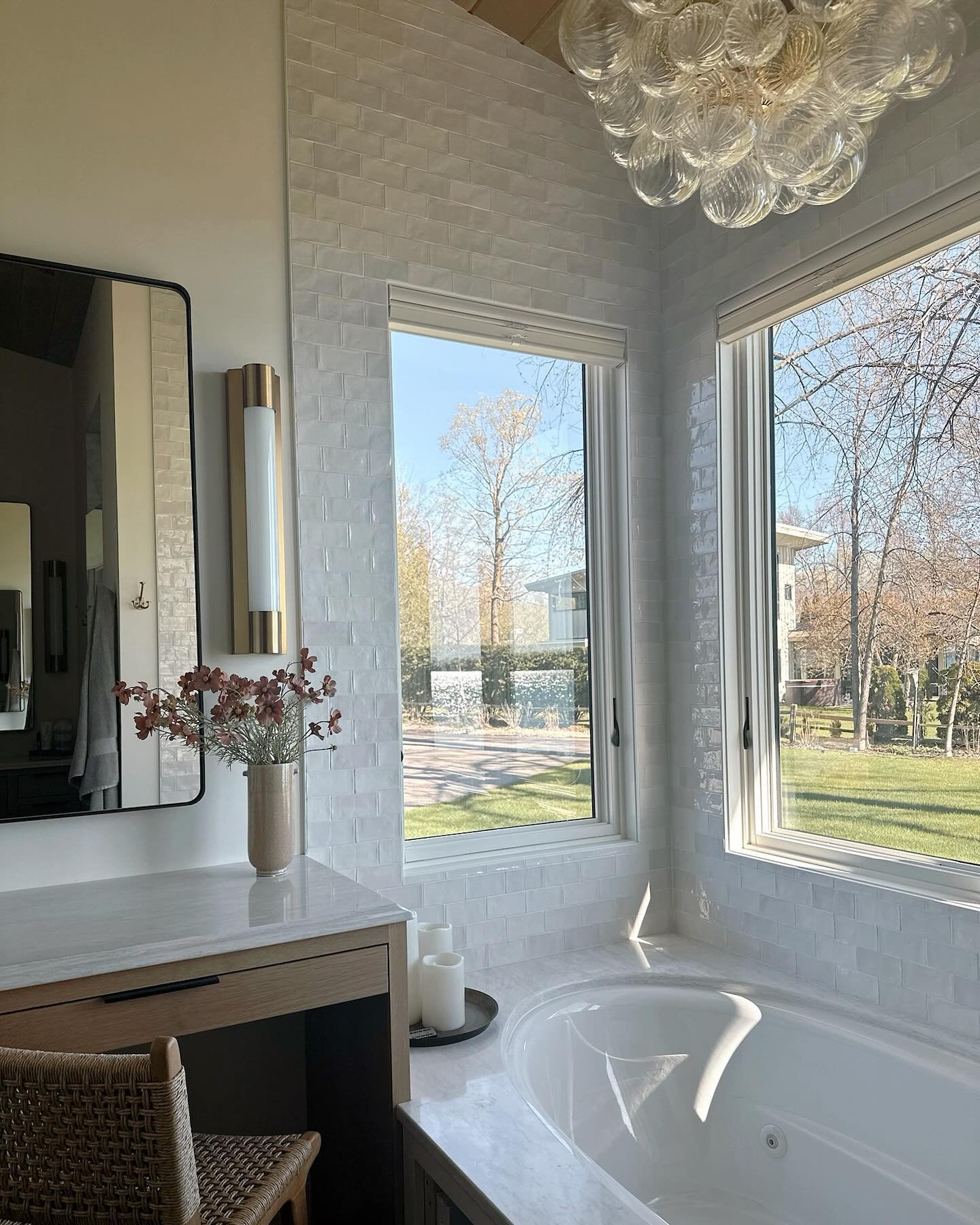 Take a glimpse into this primary bathroom suite featuring a gorgeous built-in tub embraced by quartz and tile, complemented by the delicate charm of this artisanal glass chandelier. It&rsquo;s time to unwind in pure style! #BathroomSneakPeek #DreamHo