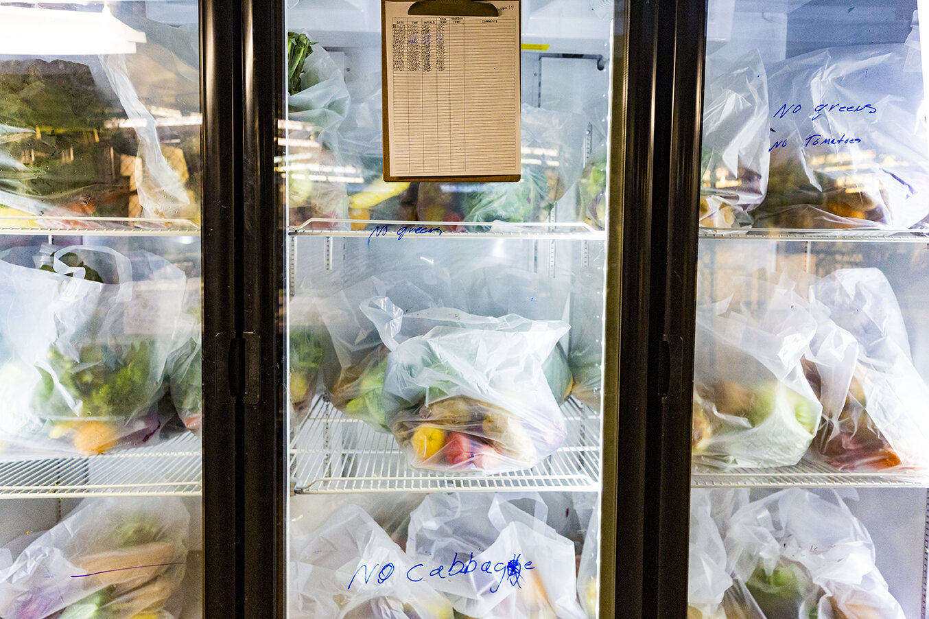 Bags of food in the storage units of Friends for Life's food pantry