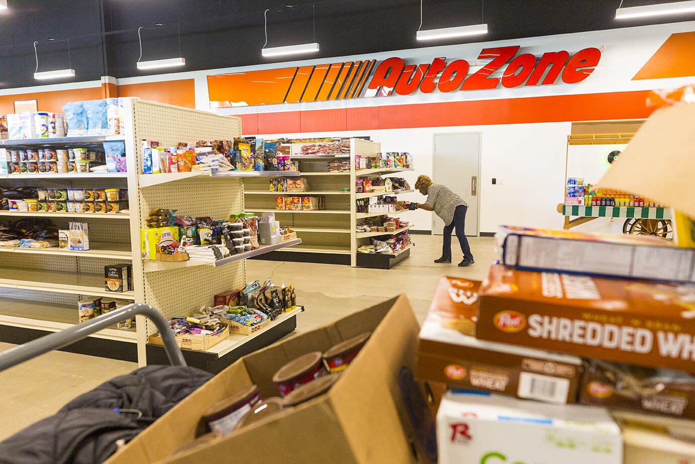 Elenor Franklin picks items from the shelves of the Agency Mart to check out