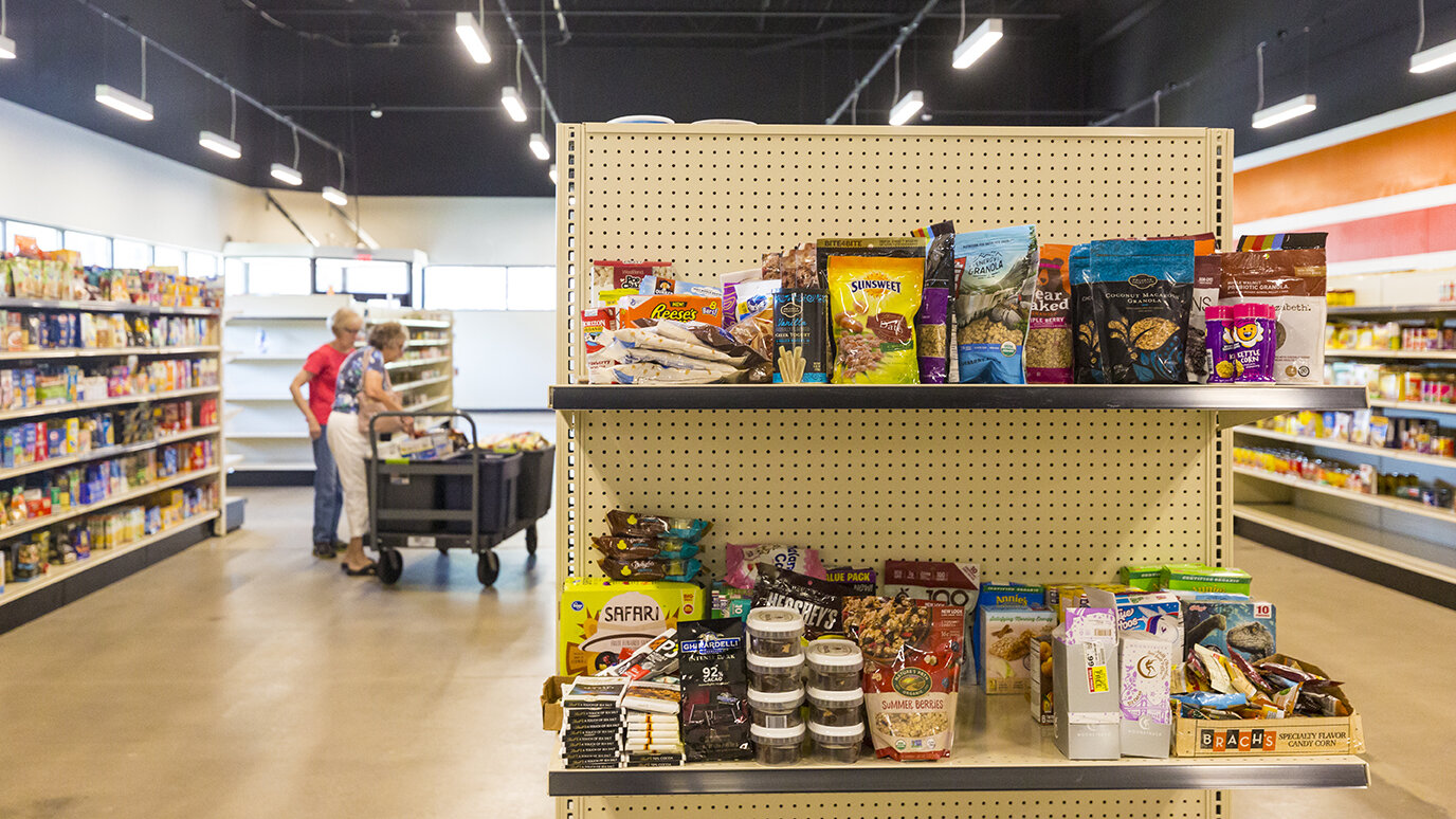Claudia Baker and Pat Edmiston of the St. Vincent DePaul Society for St. Michael's Church pick items from the shelves of the Agency Mart to check out