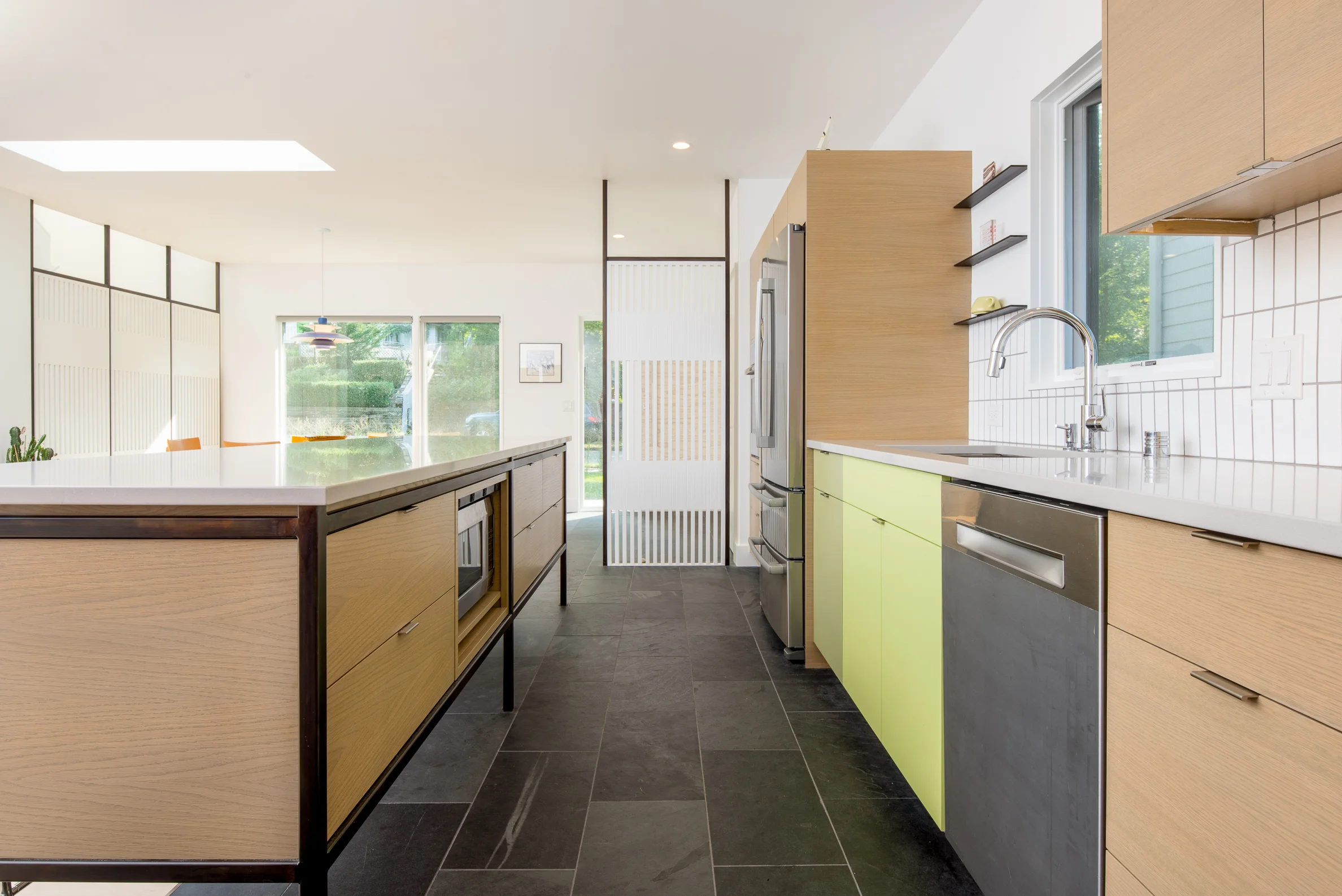 Custom midcentury kitchen with colorful cabinetry and steel accents
