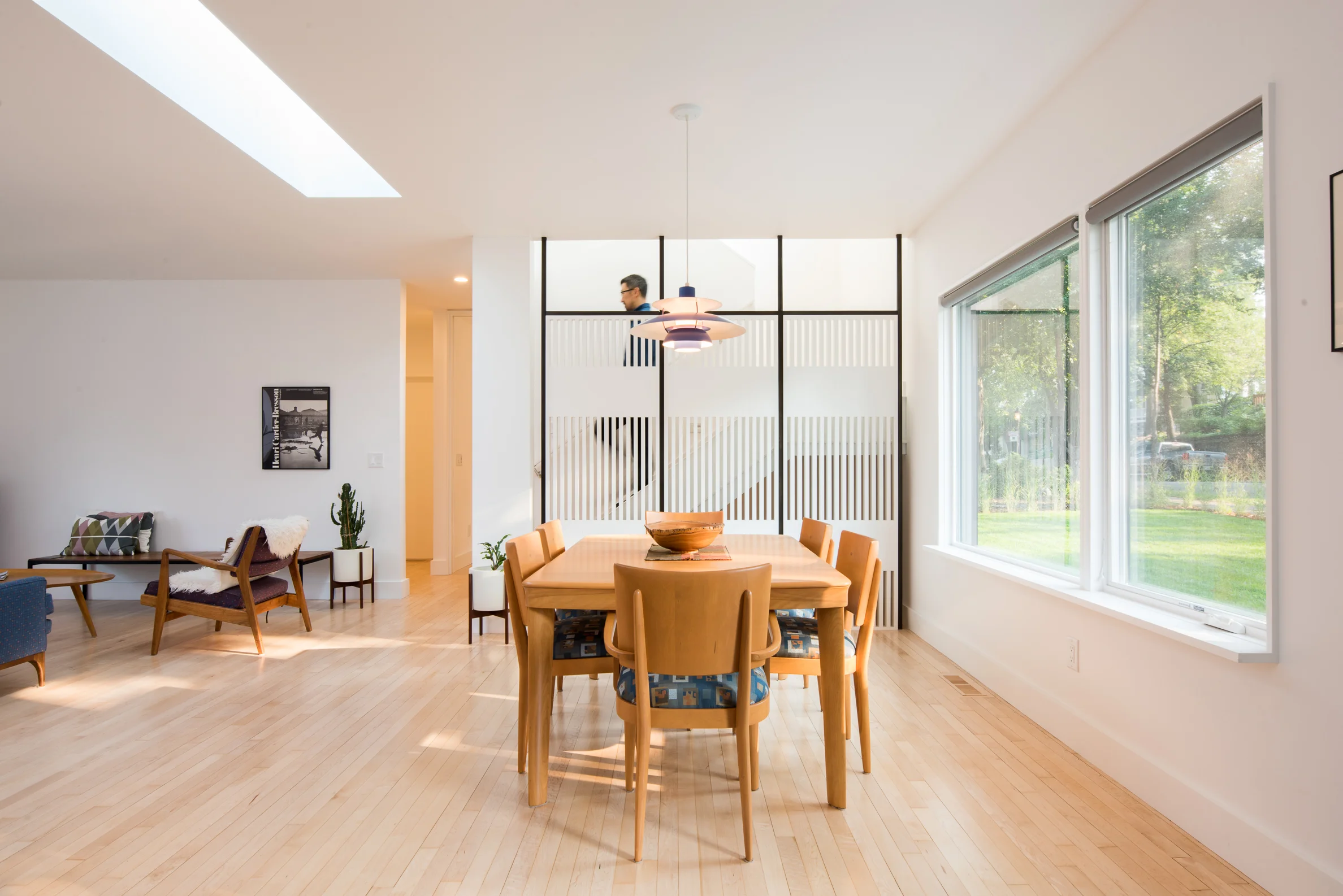 Mid-century dining room table in front of custom wood screen wall