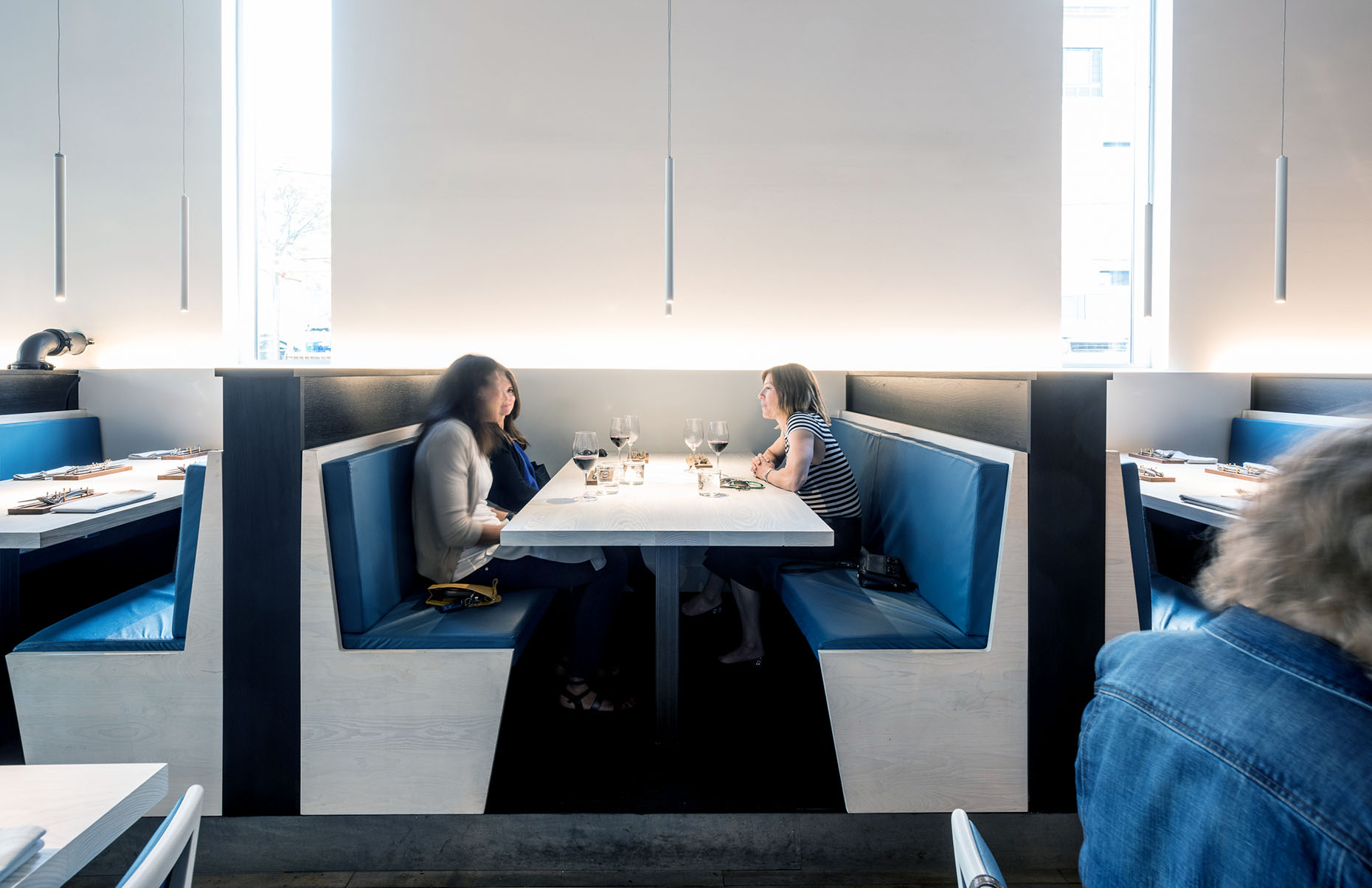 custom wood dining booths with blue leather seats