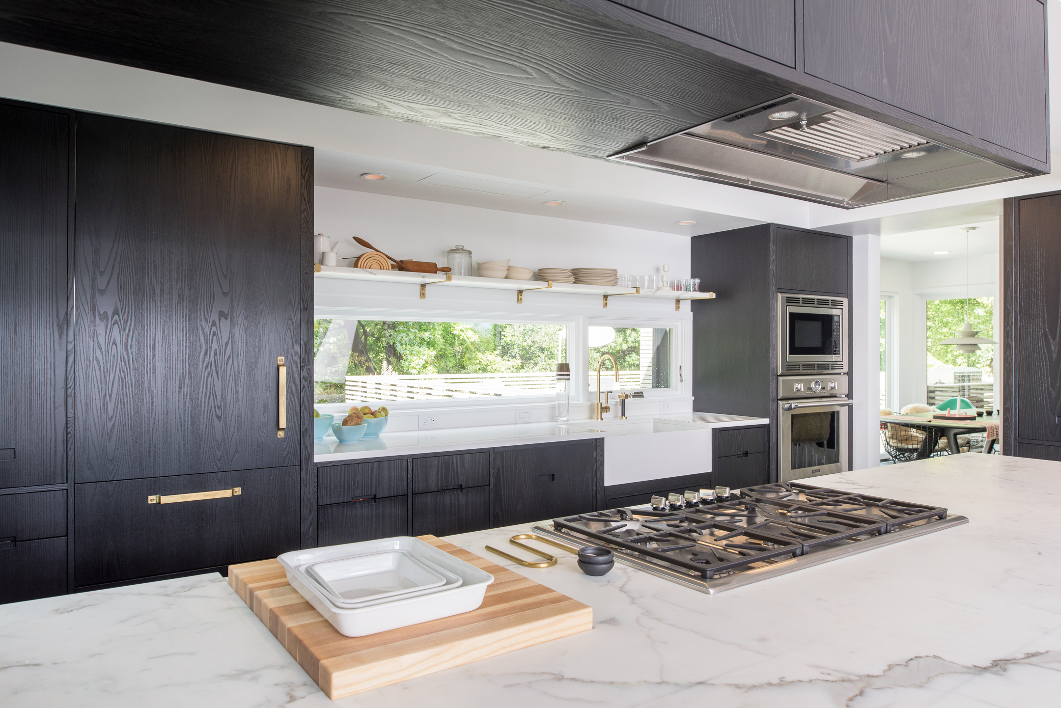 Modern kitchen remodel detail of marble countertop and brass hardware