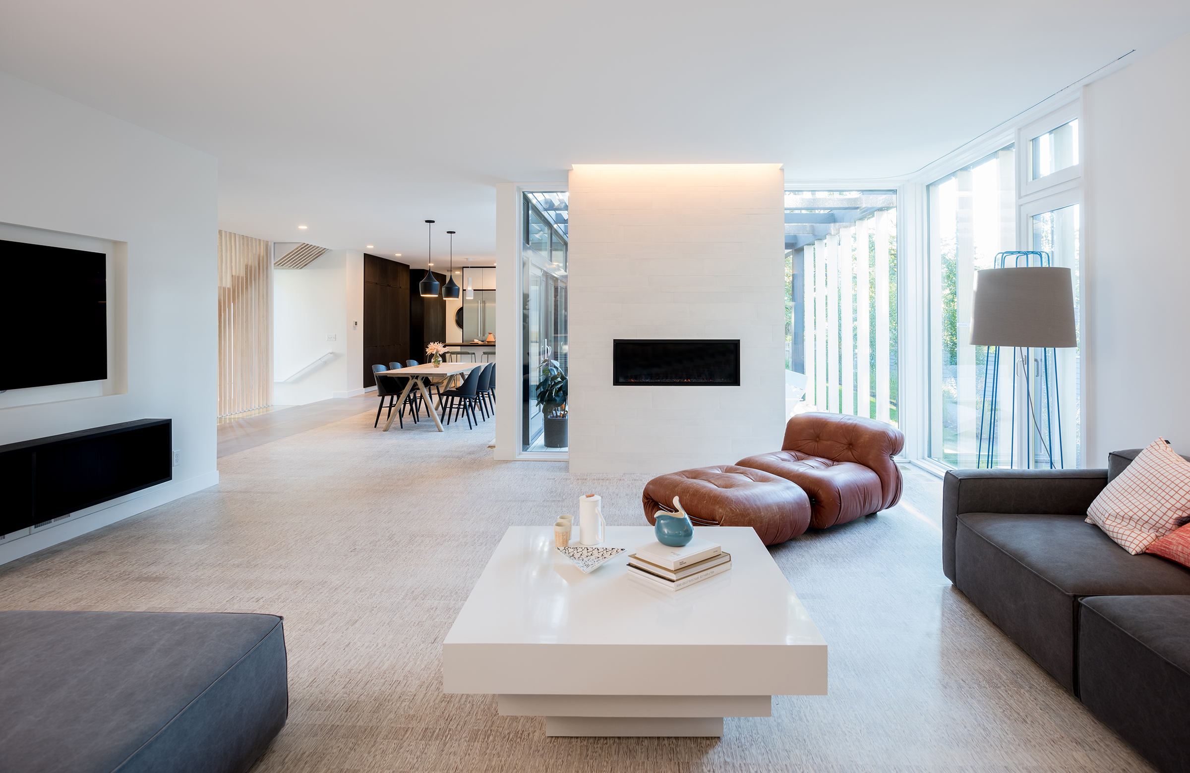 Modern living room with wood floors and fireplace wall