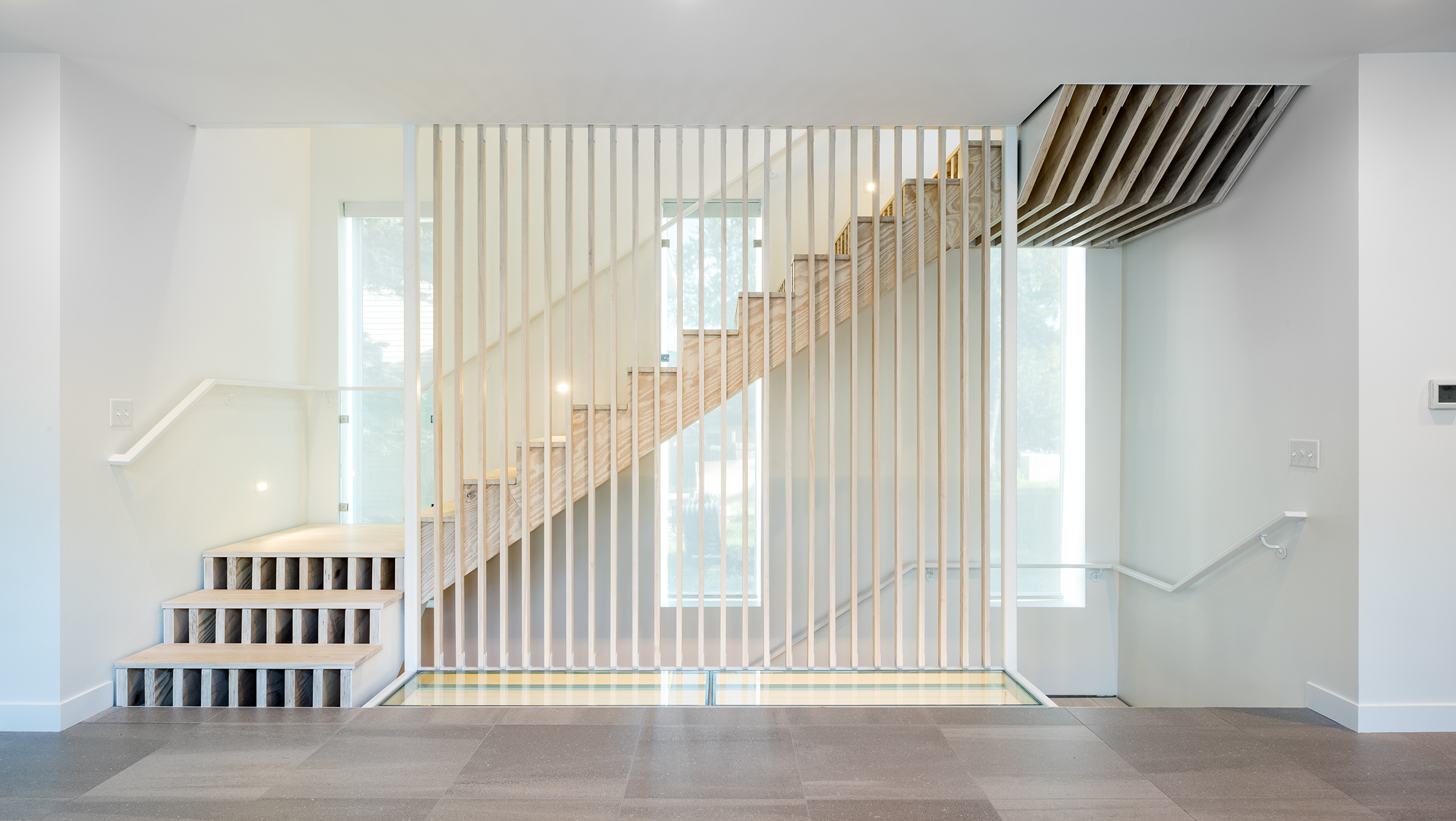 Custom accoya staircase with exposed stringer and glass floor detail