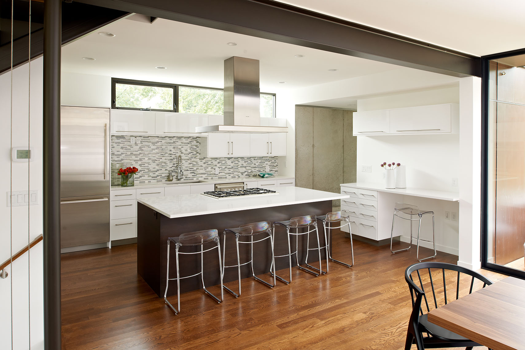 Modern bright kitchen with white cabinetry and center breakfast bar