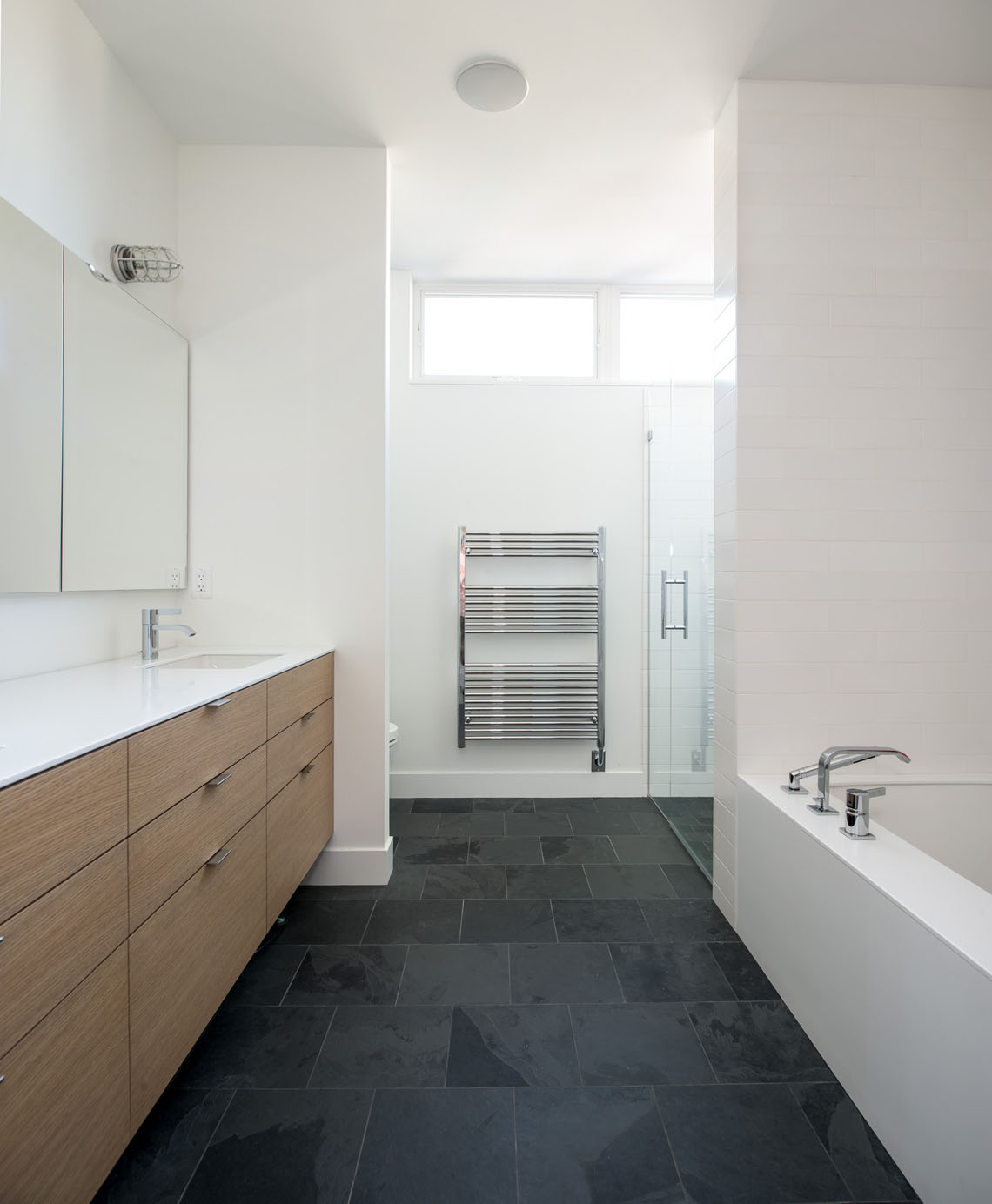Minimal monochromatic master bathroom designed by Christian Dean Architecture