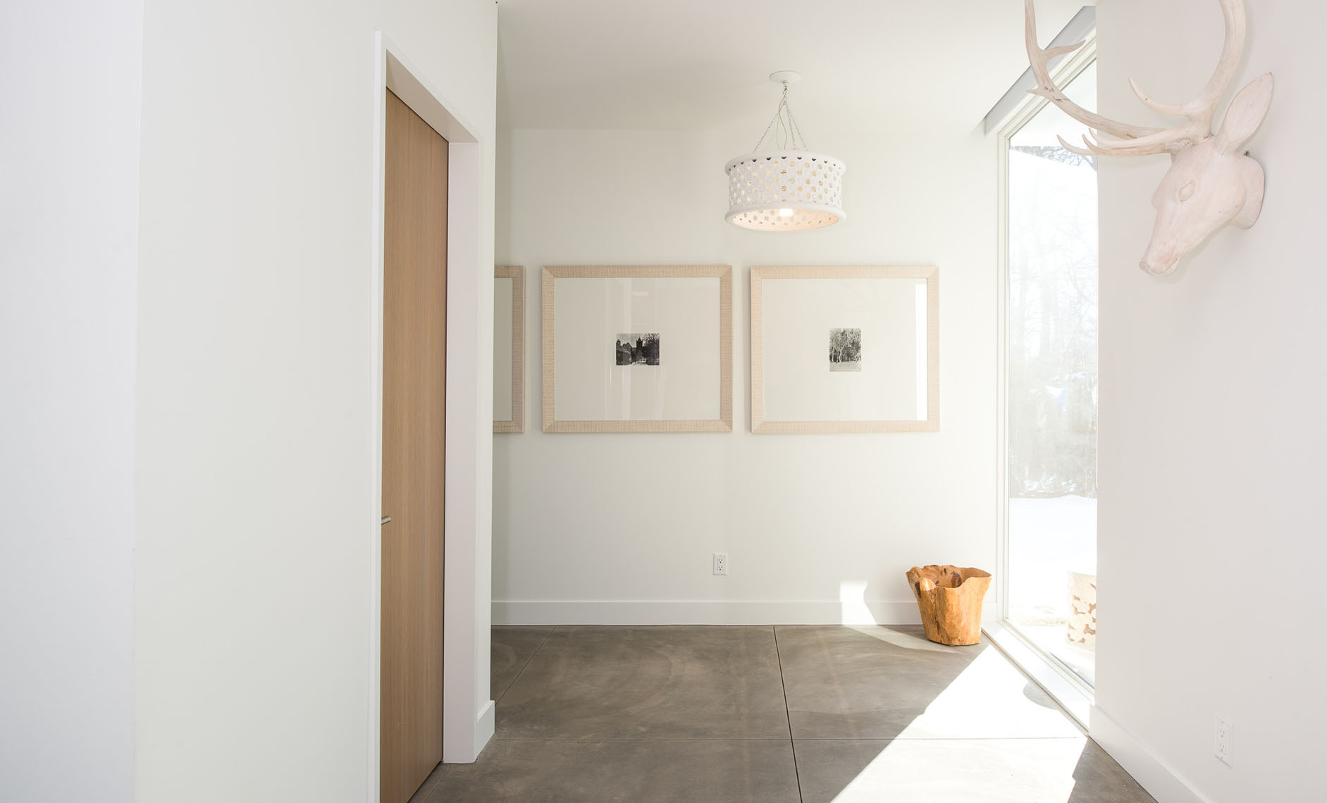 Hallway with a concrete floor and white walls