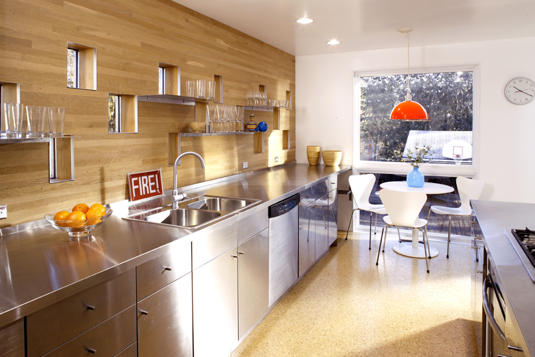 Modern kitchen with steel counter and wood backsplash
