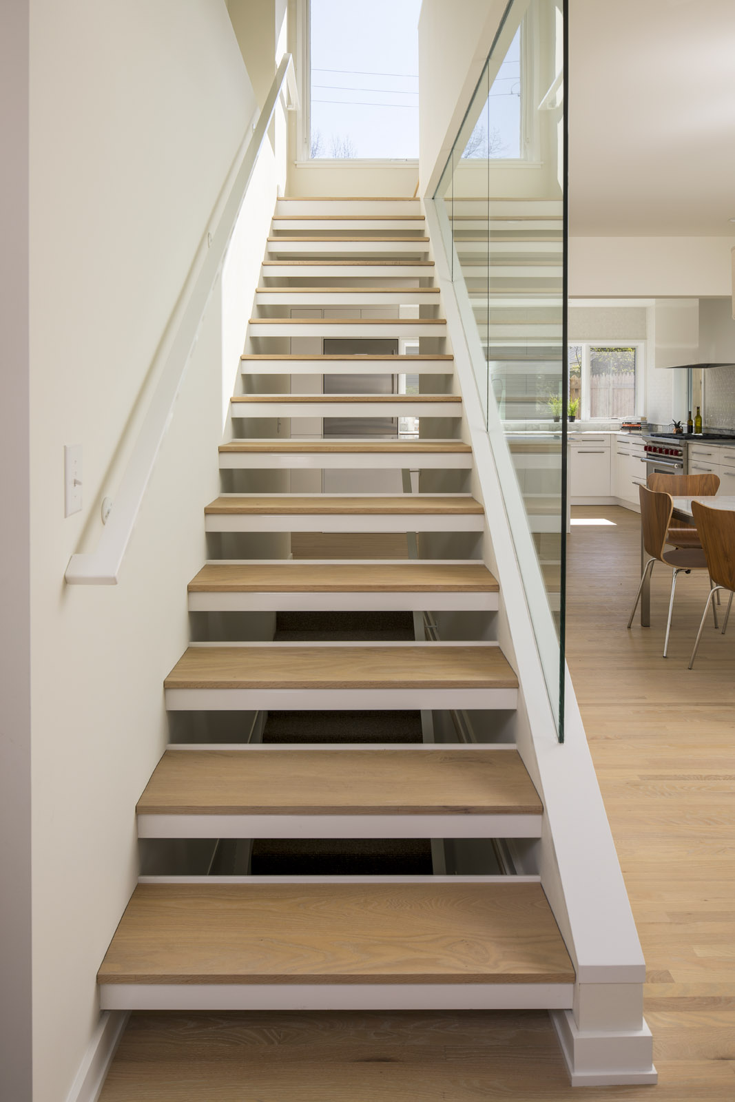 Custom open wood stair tread detail in modern home