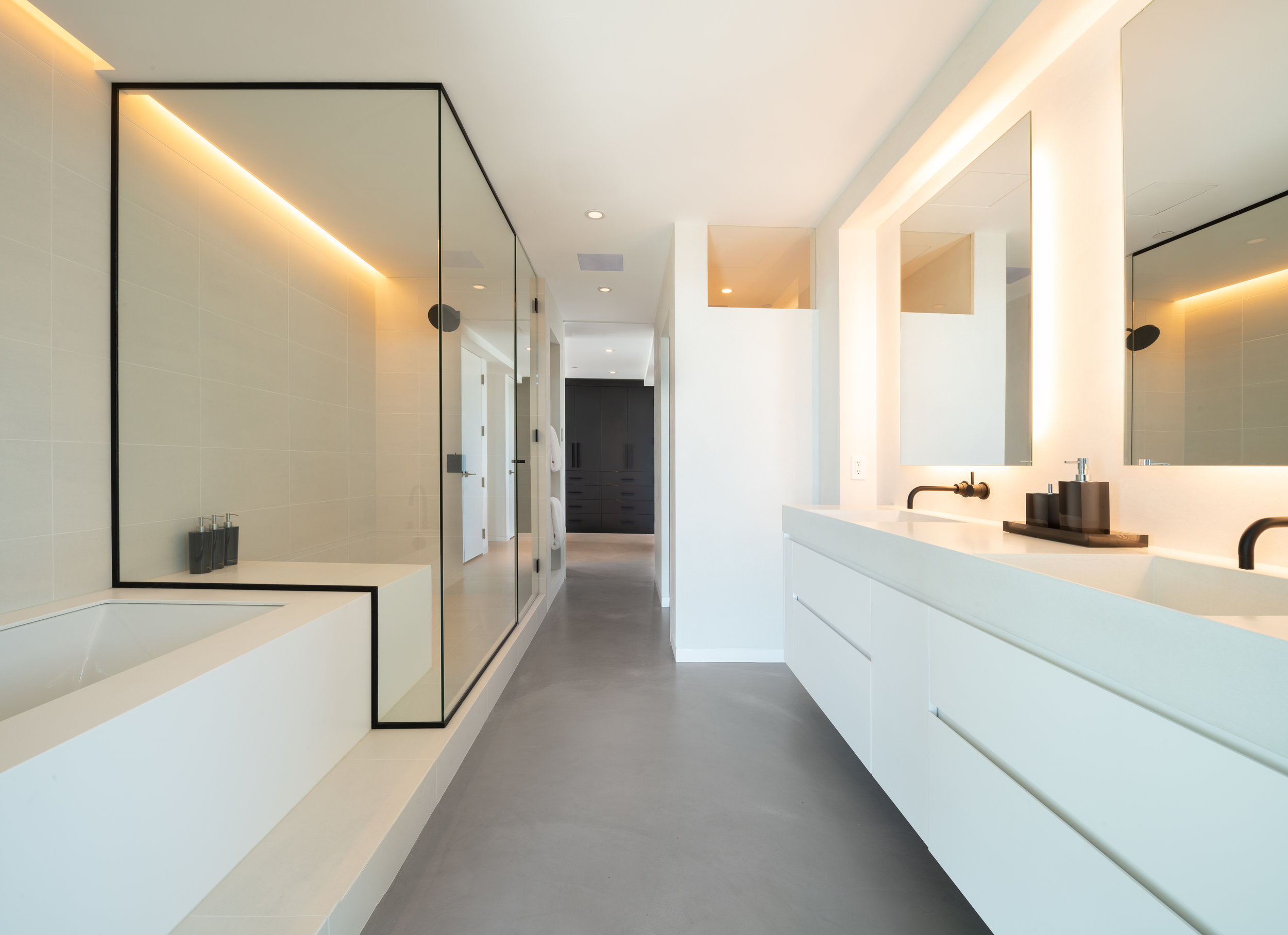 Modern white bathroom with walk-in shower and light cove detail