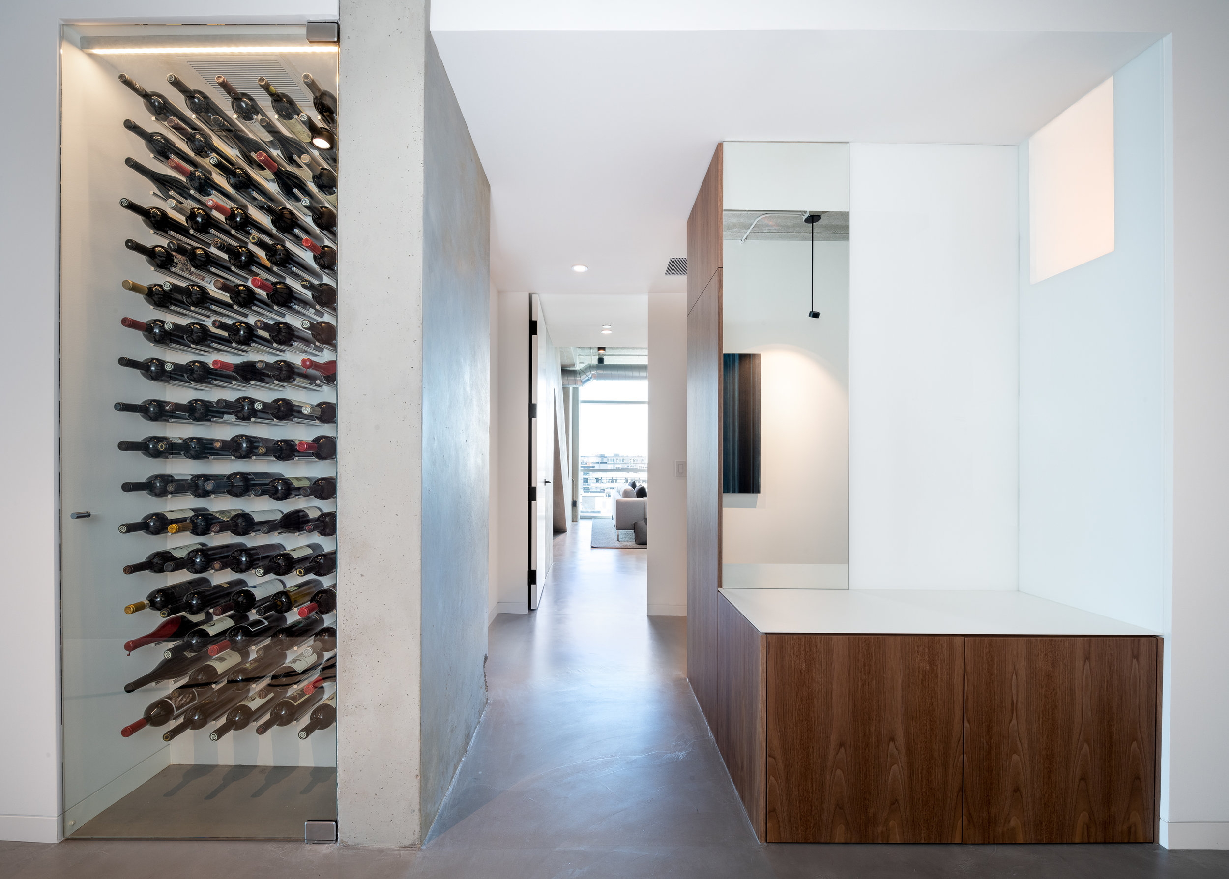 Custom wine storage and coat closet in loft foyer