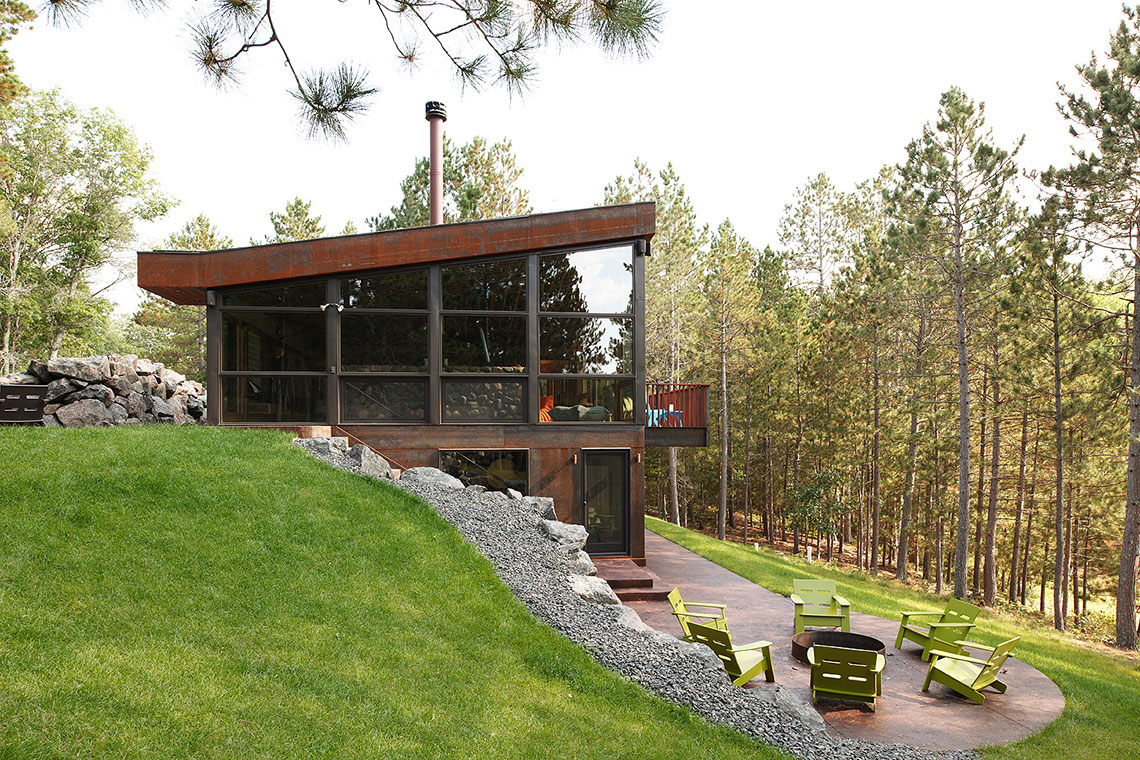 Modern cabin with large windows and exposed basement