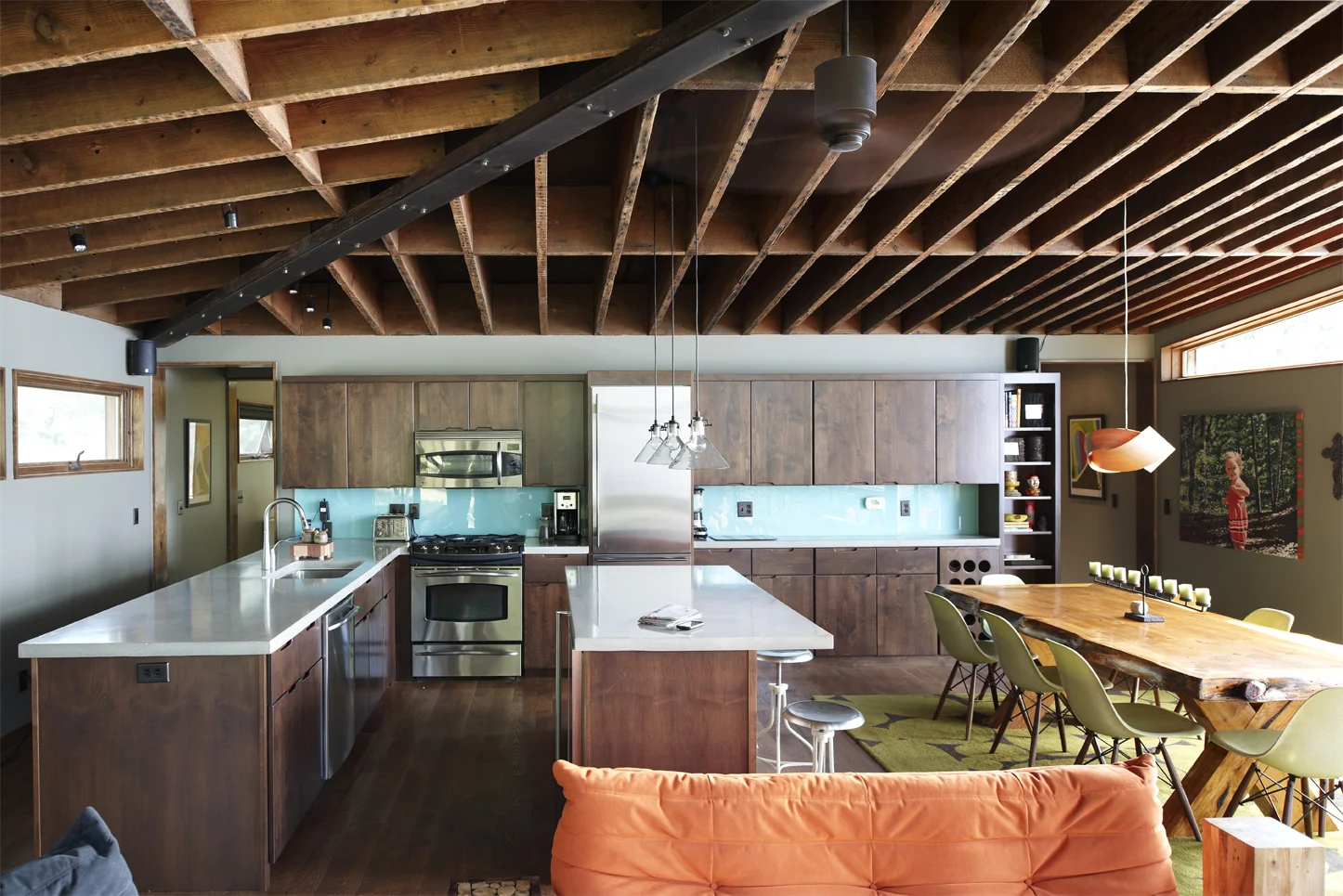Dark wood kitchen with bright blue backsplash in a modern cabin