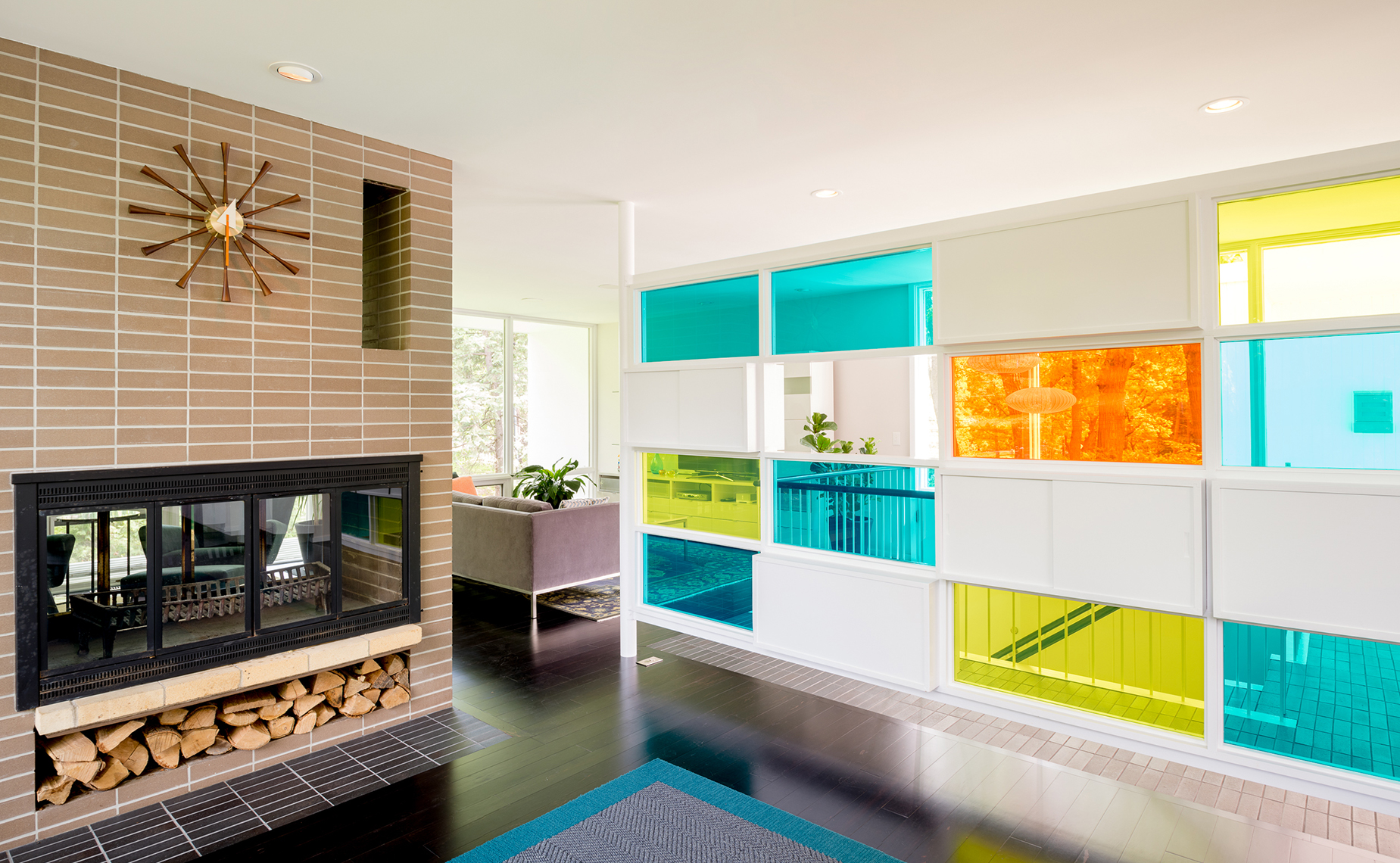 Midcentury brick fireplace and colorful divider wall
