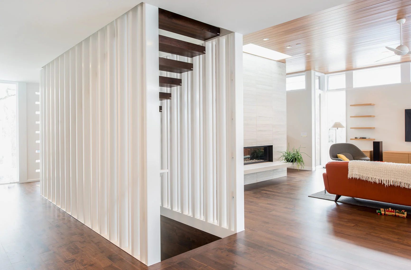 Custom floating tread stair with slat walls