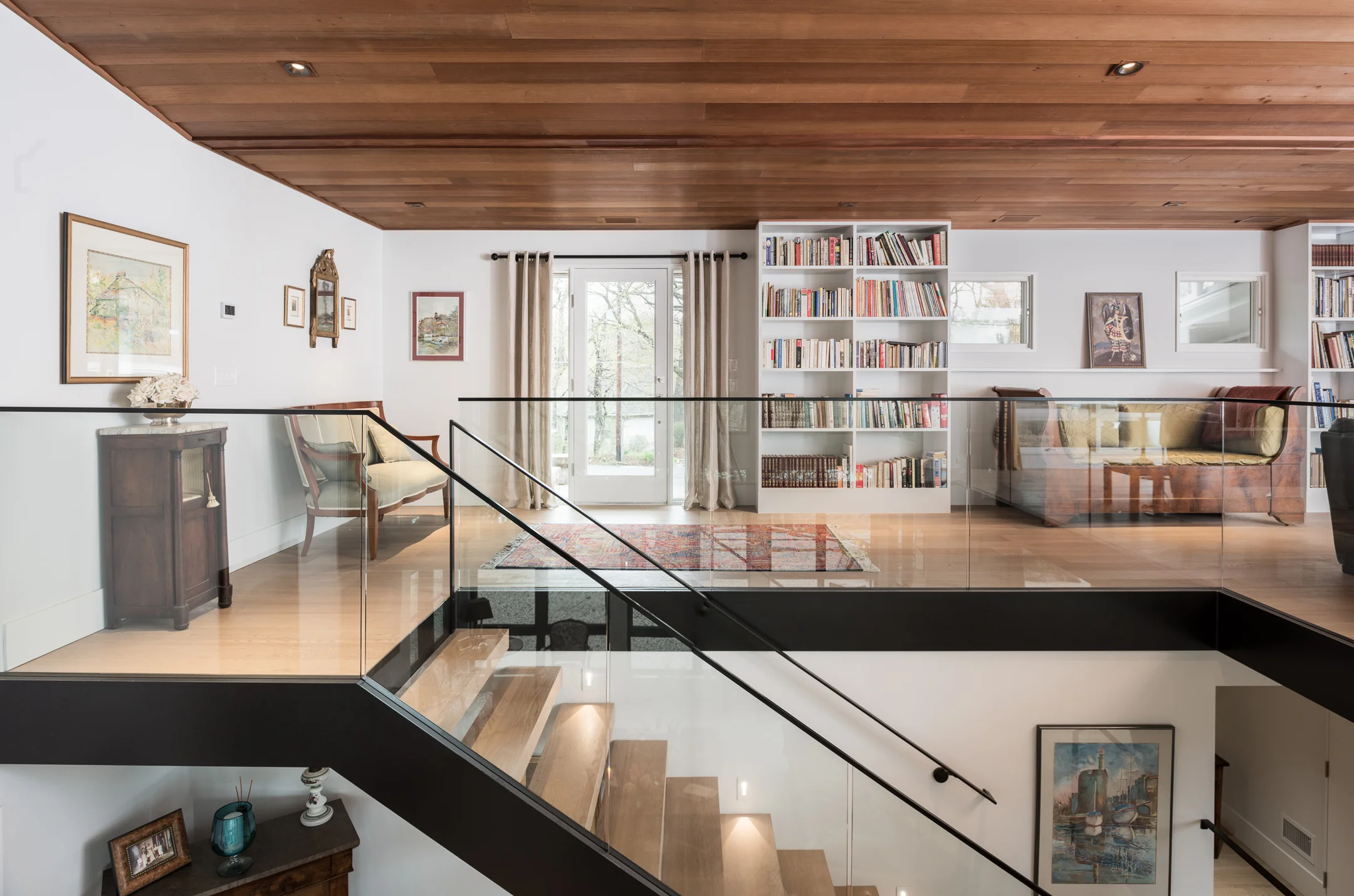 Floating tread stair with modern steel and glass handrails