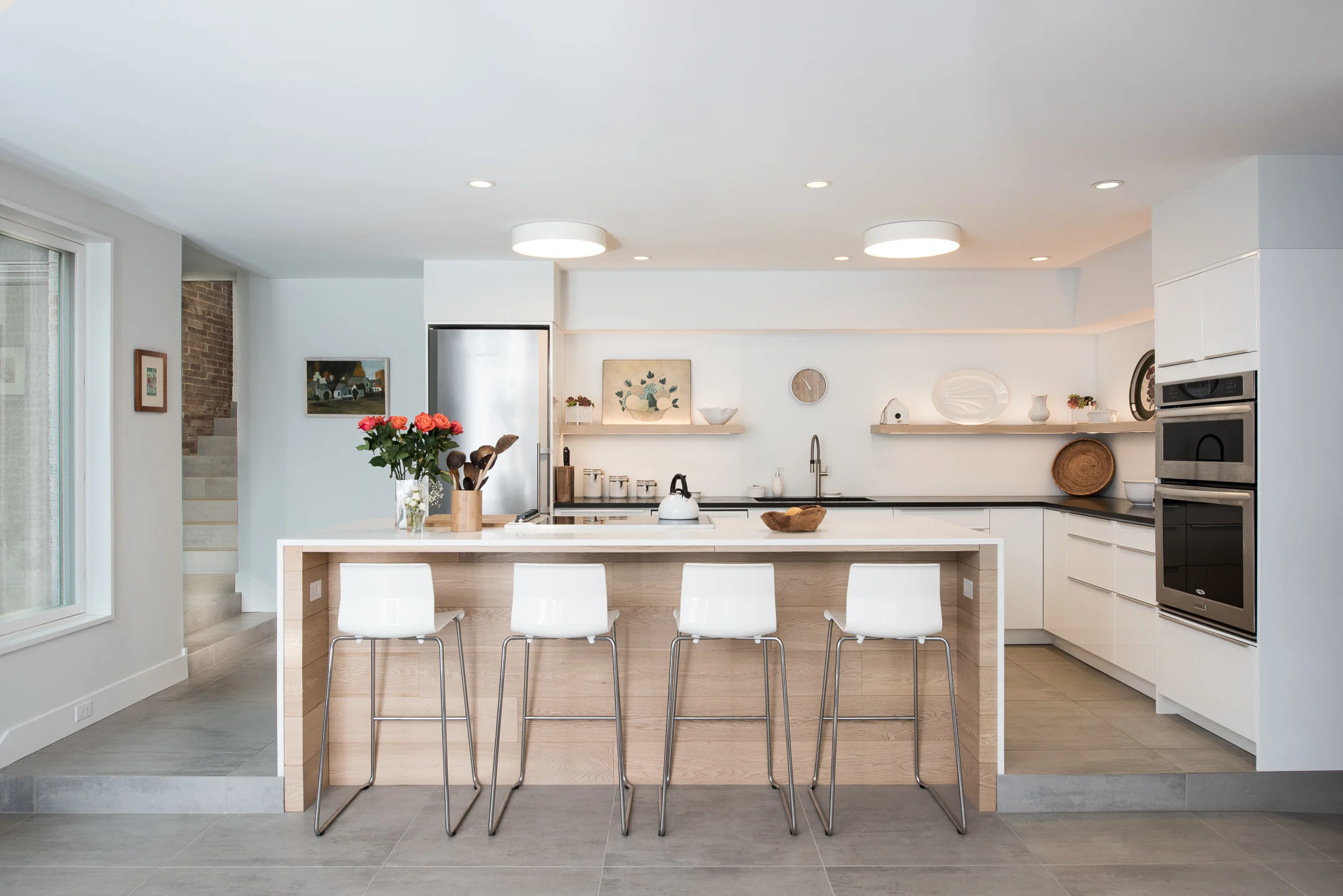 Modern monochrome kitchen with wood accents designed by Christian Dean Architecture