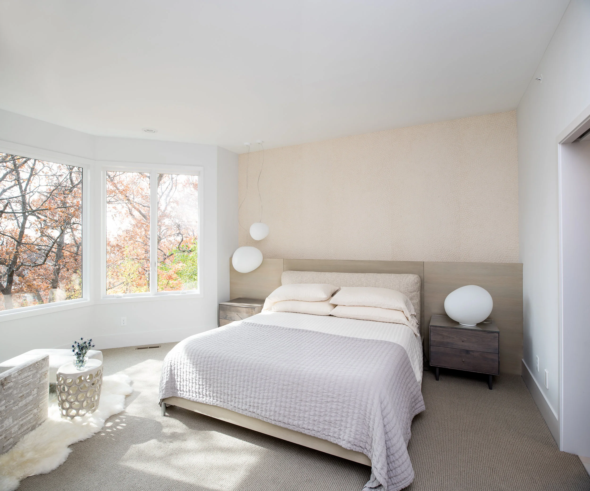 Modern master bedroom with pendants and minimal wallpaper
