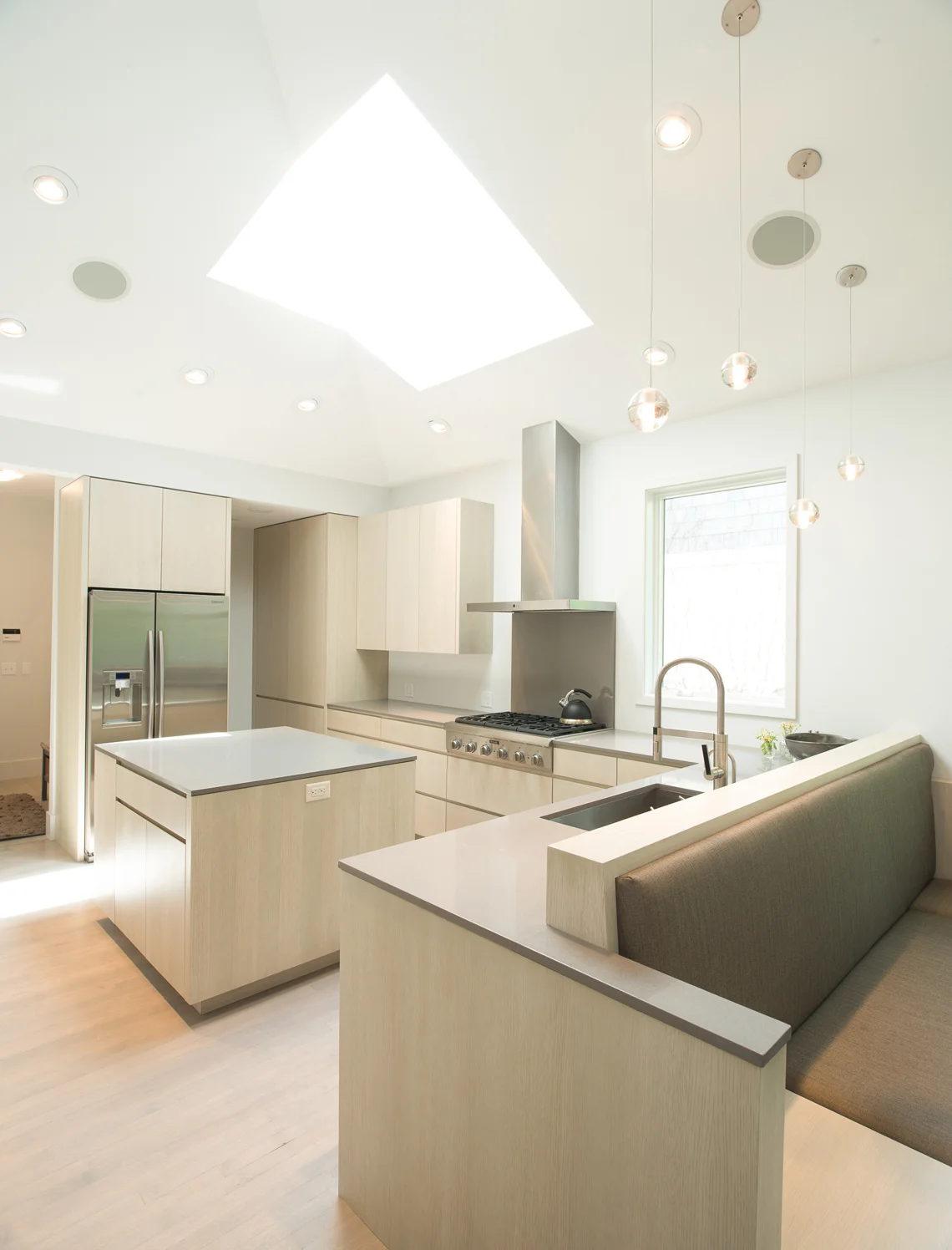 Modern minimal kitchen renovation with custom cabinetry and bench details