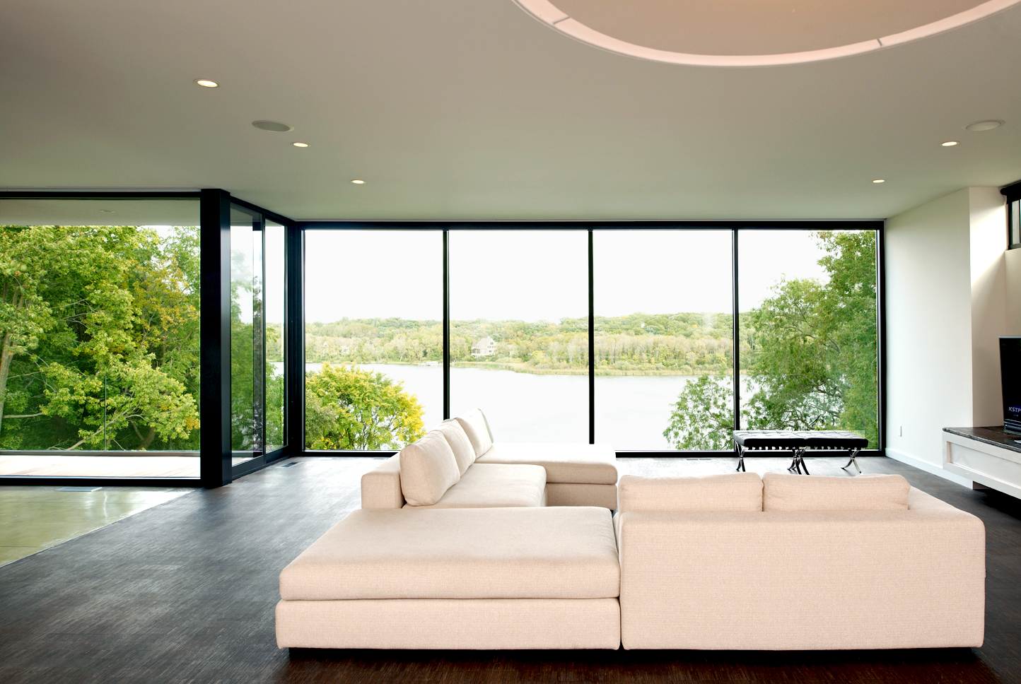 Modern minimal living room with glass wall to outdoors