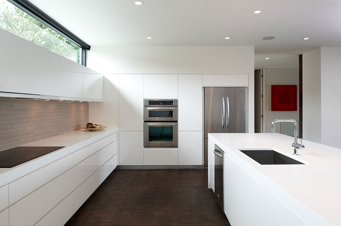 Minimal white kitchen with clerestory windows