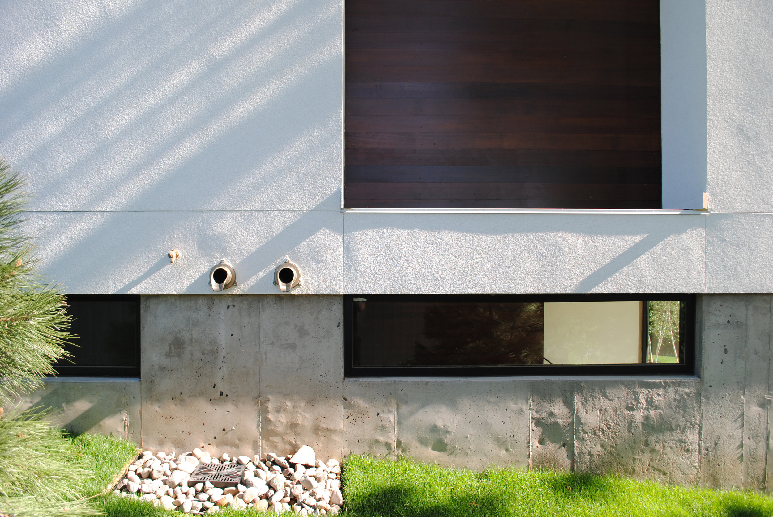 Cement, stucco, and wood exterior cladding detail