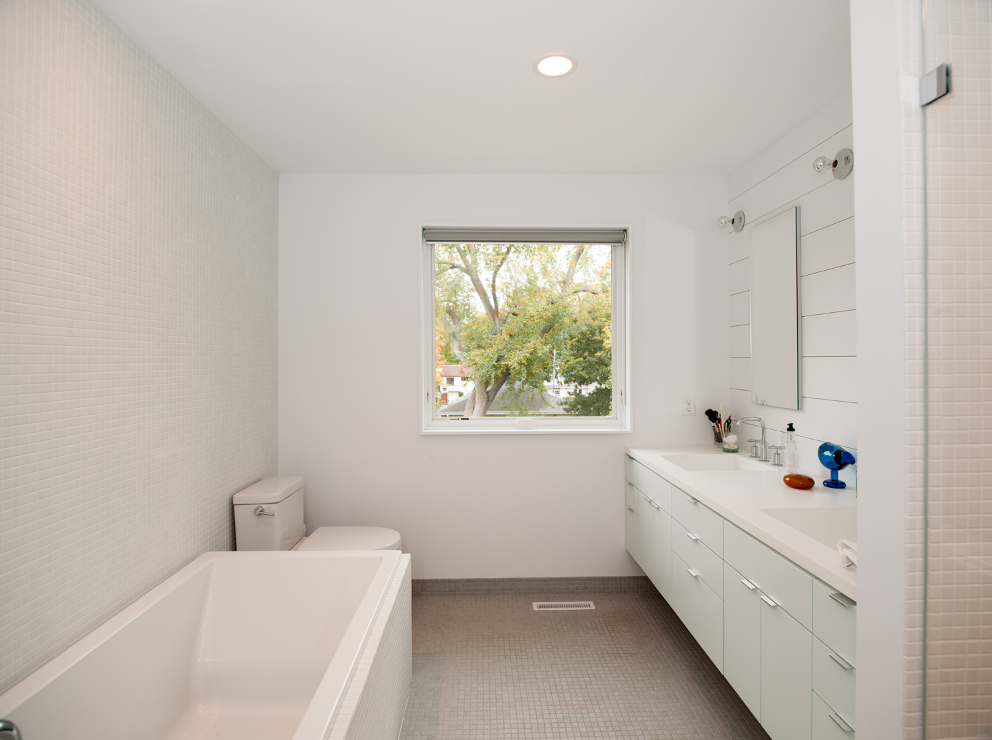 Modern bathroom renovation with tiled walls and custom floating vanity