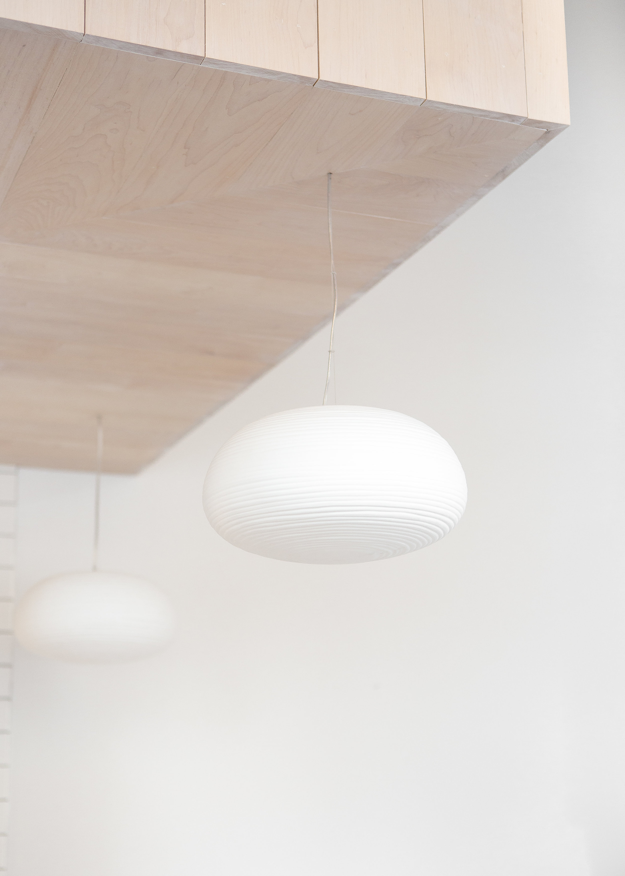 custom wood ceiling detail with white pendant lights