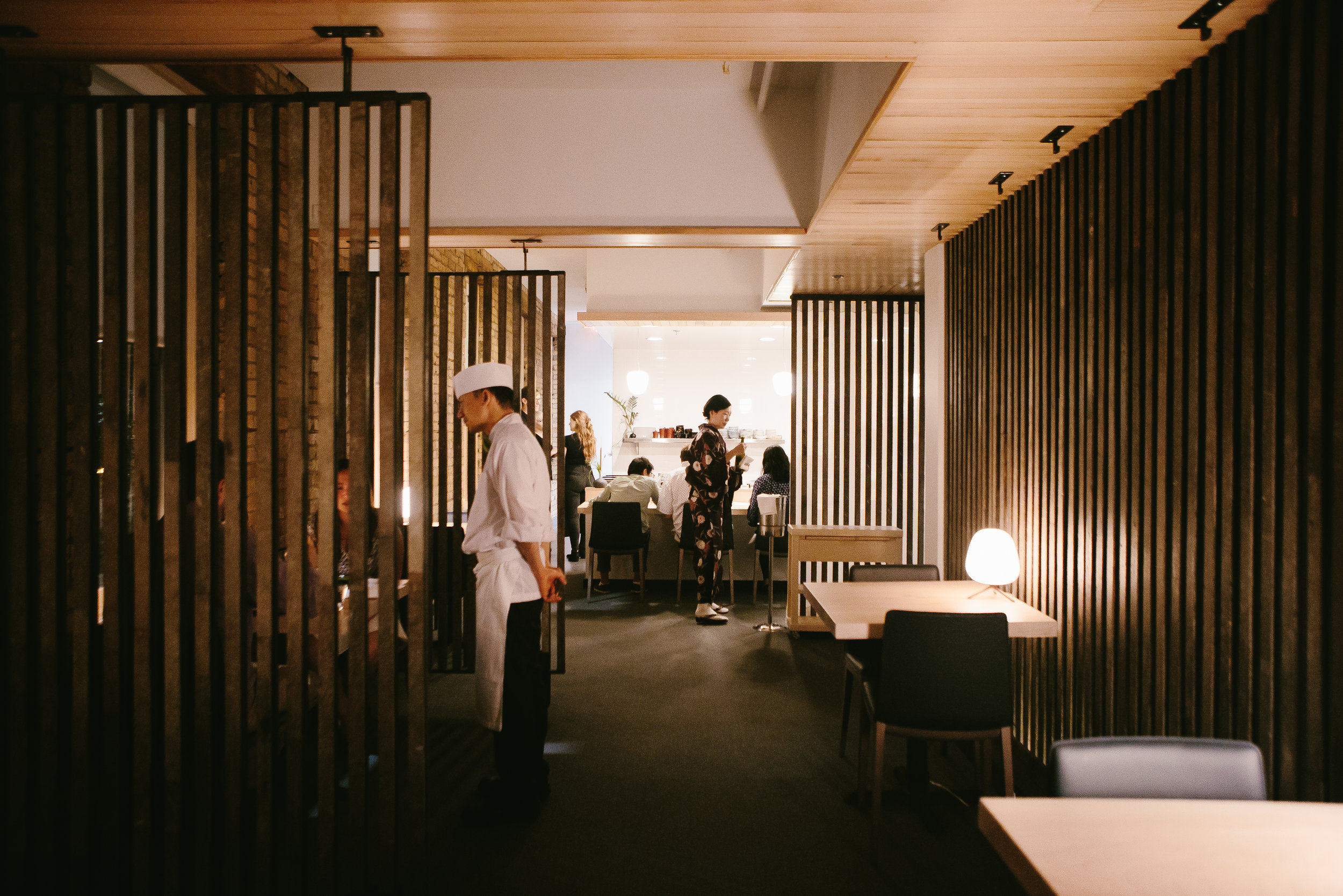 modern japanese restaurant with wood slat dividers and custom wood ceiling details