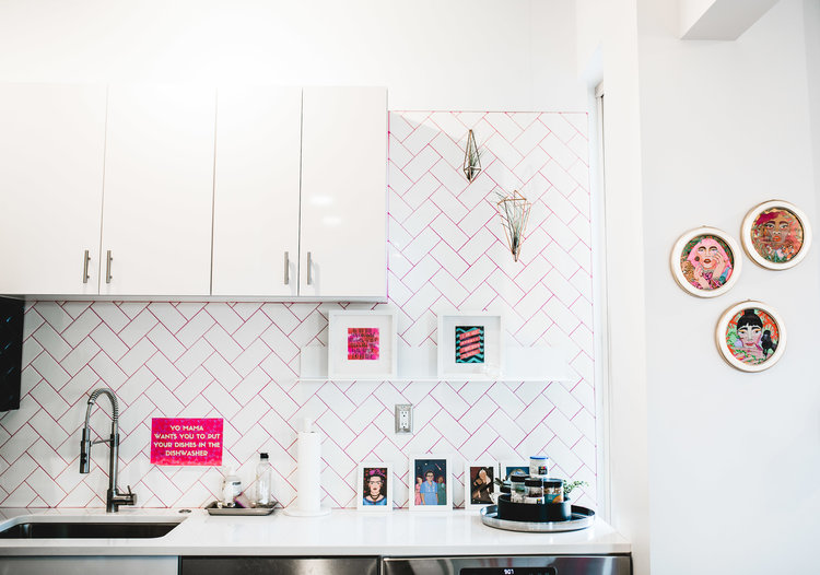 modern kitchen remodel with white herringbone tile layout and pink grout