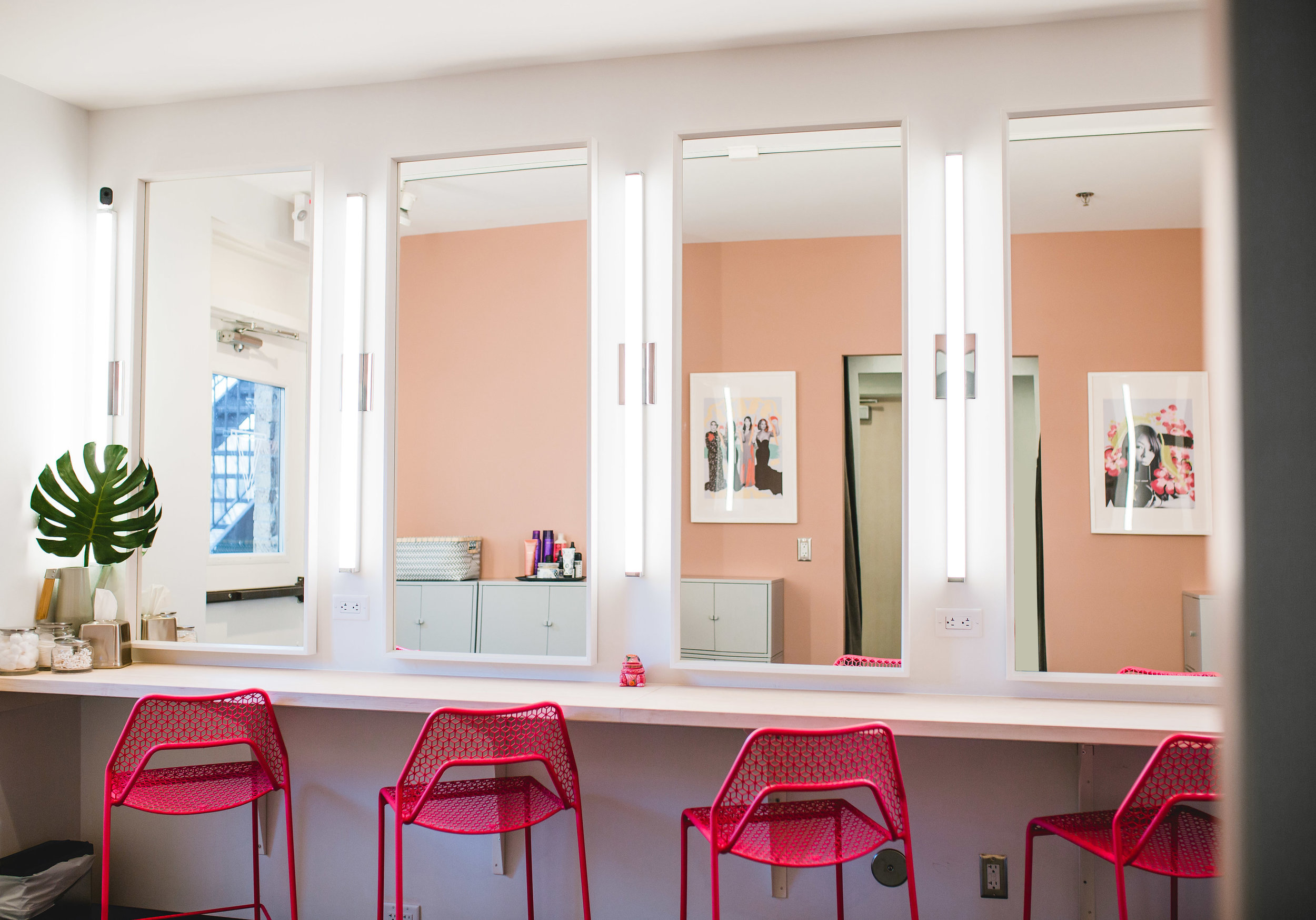 modern co-working space dressing room with hot pink blu-dot chairs