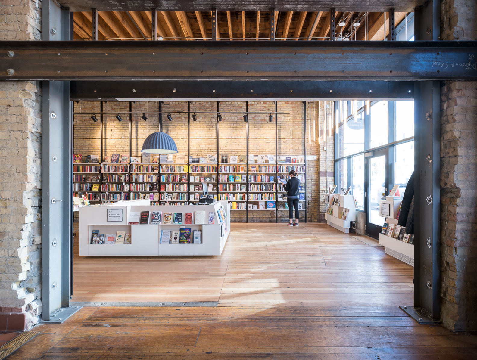 modern bookstore remodel in historic building with exposed structure by christian dean architecture in minneapolis