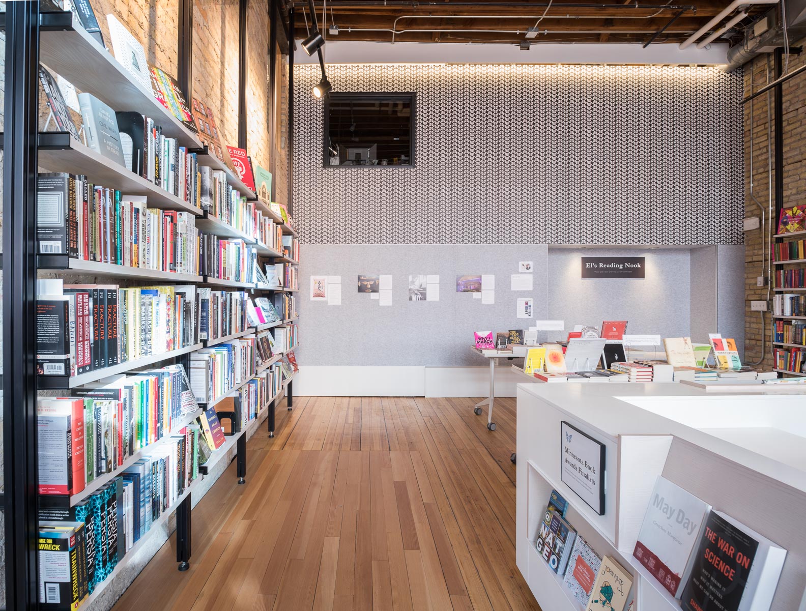 custom open bookshelves and custom white desk in modern bookstore remodel