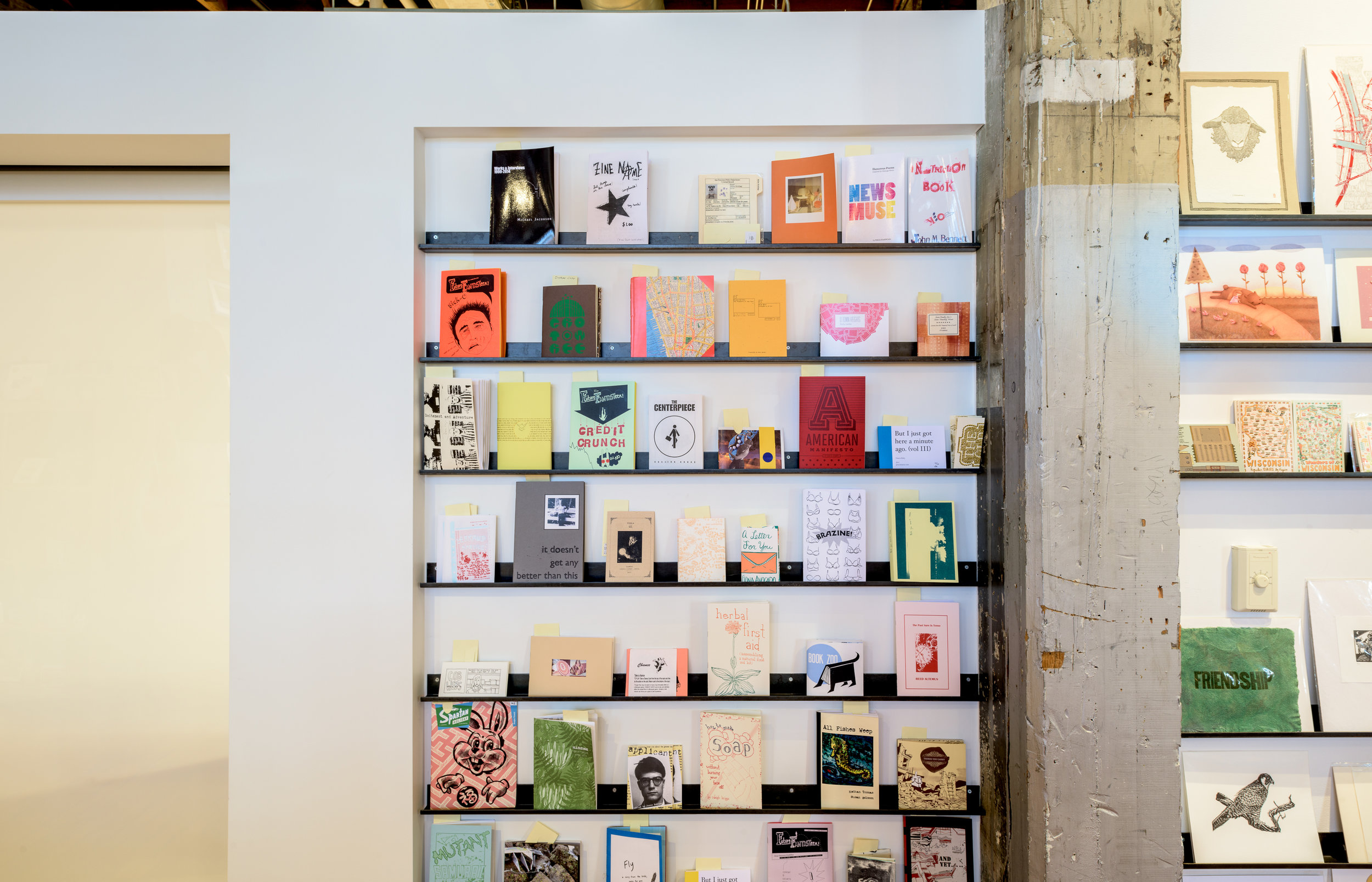 Custom modern black metal display shelves in Minneapolis gift shop by Christian Dean Architecture.