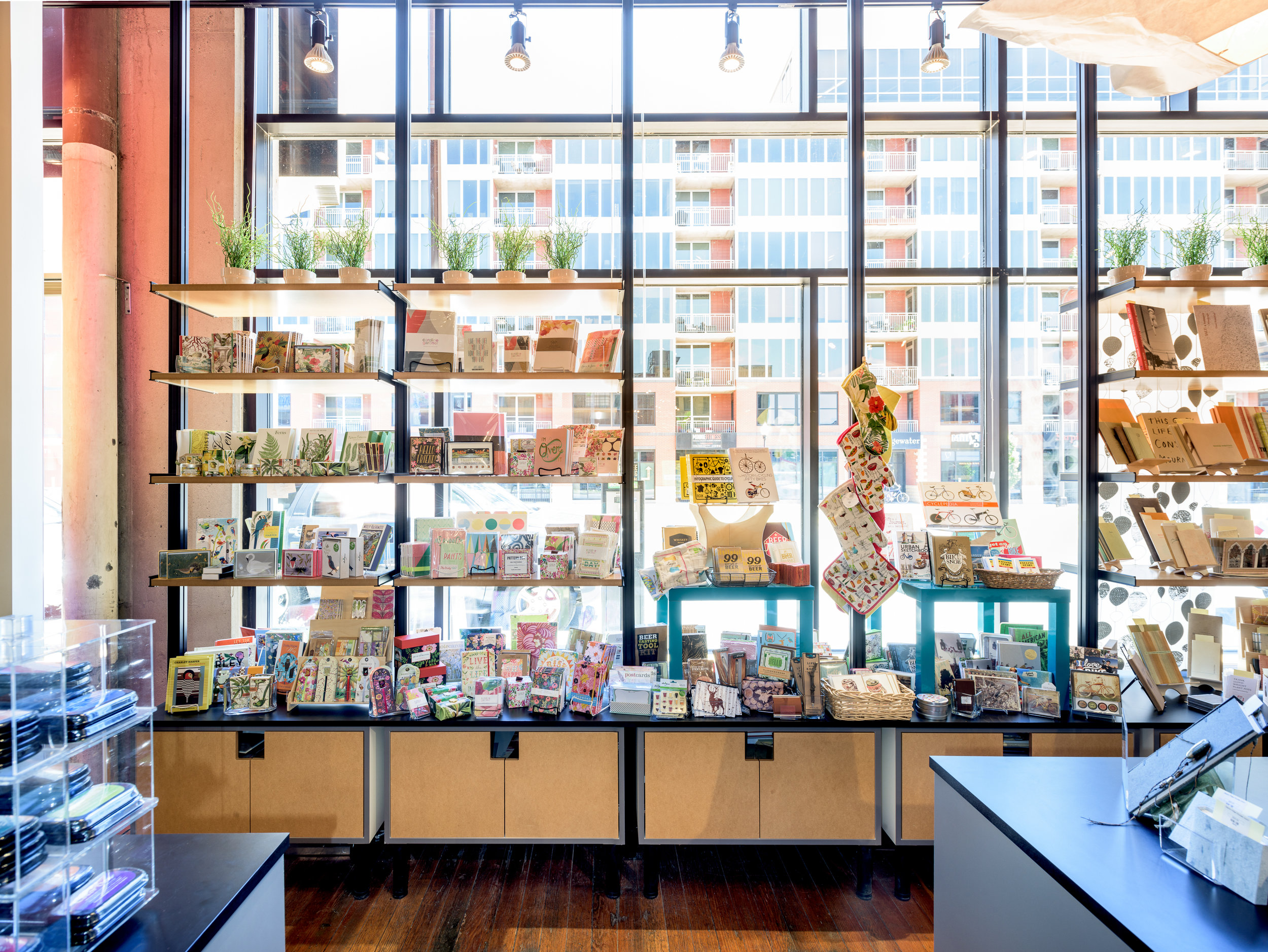 Custom steel and wood open display shelves in modern gift shop in Minneapolis. 