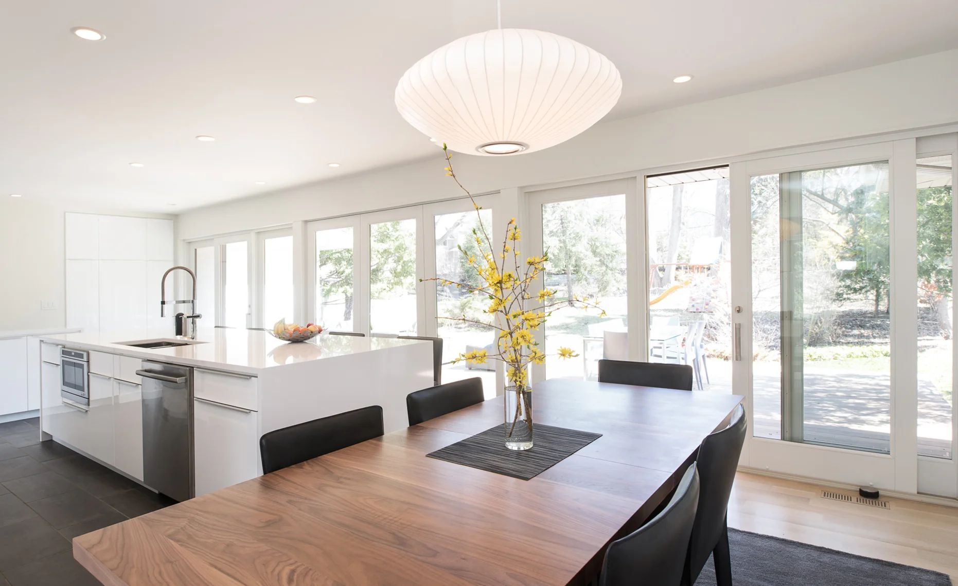 Modern dining area within bright white kitchen