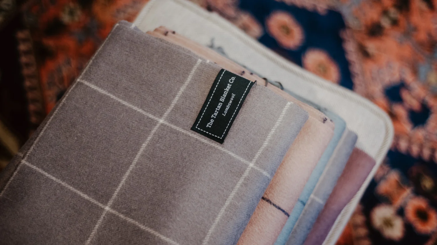  The labels were designed to wrap around the front and back of the blankets and scarves. The unique label design stood out from competitors labelling styles as well as allowing the blankets and scarves to be hung on coat racks. 