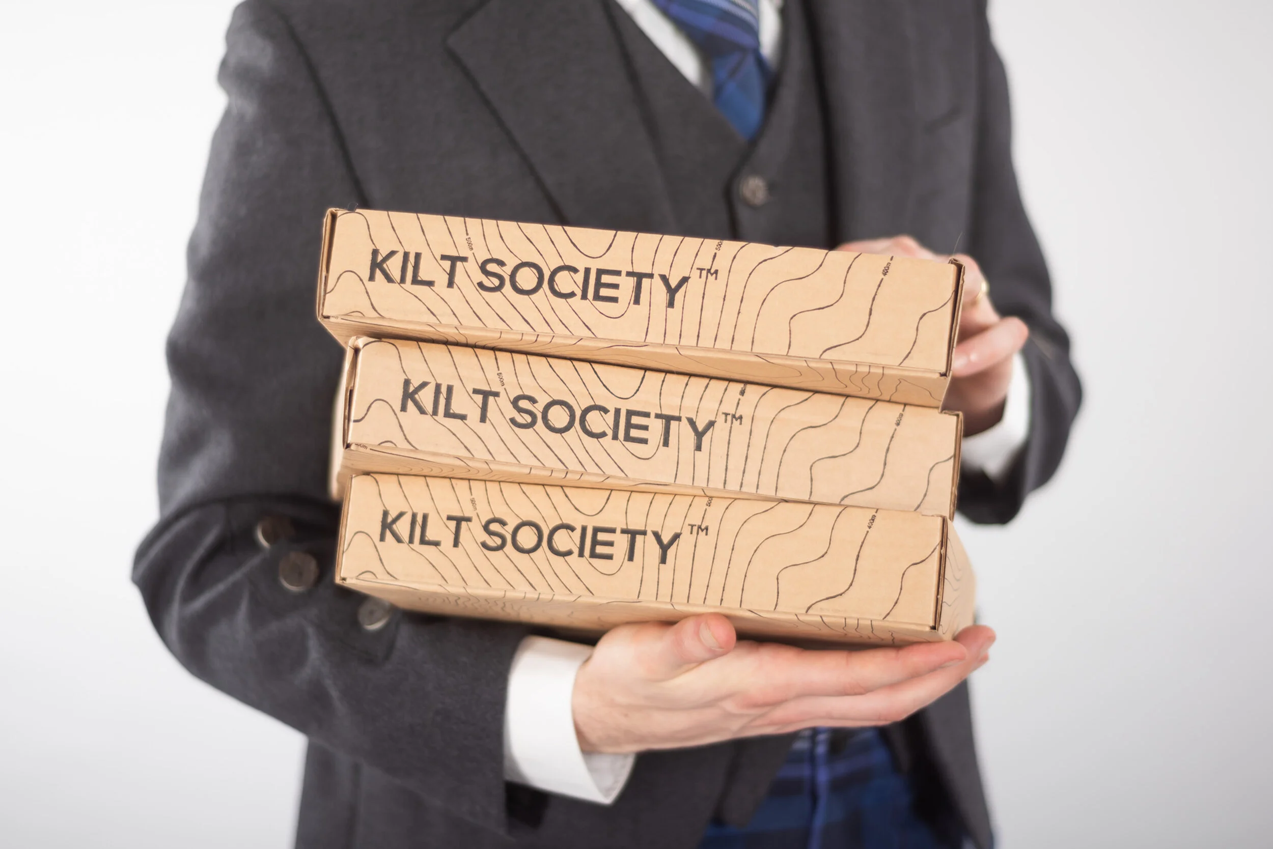  The many products sold on Kilt Society are varied in shapes and sizes. Multi-use recyclable paper bag and multiple sizes of cardboard box packaging were designed for use across these various products. 