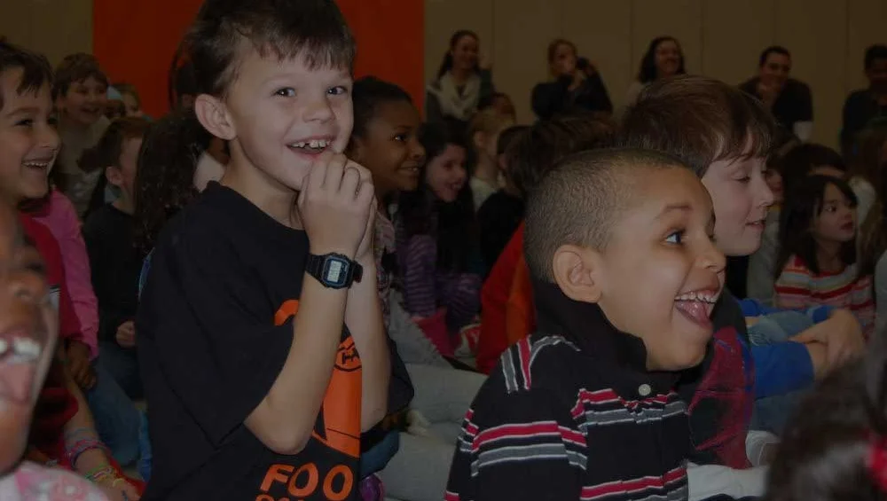 Excited elementary and middle school students in the audience