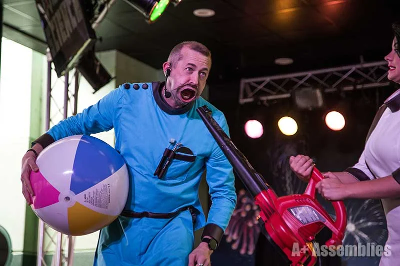 Hagerman with a beach ball and leaf blower demonstrating Bernoulli's principle in a science show