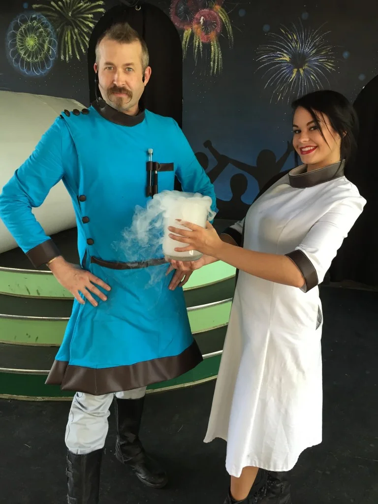 Hagerman and his assistant posing on stage