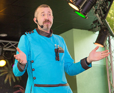 Hagerman mid-joke with arms spread wide