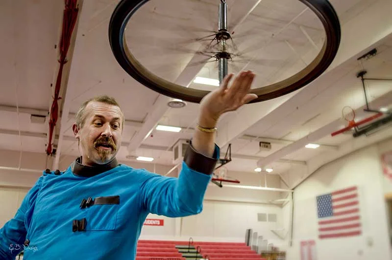 Hagerman balancing a spinning bicycle-wheel gyroscope