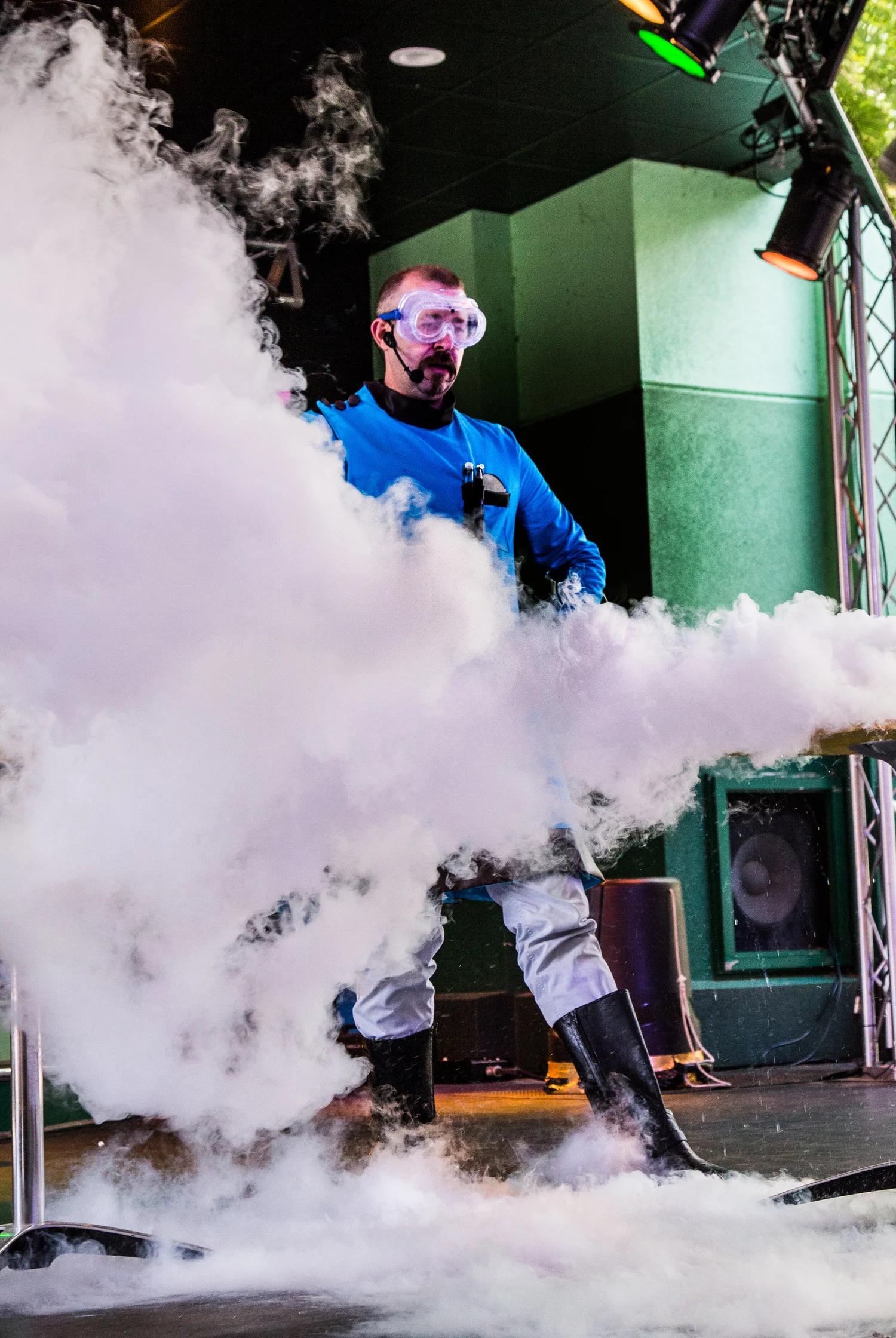 Hagerman the Science Wizard in his teal lab coat and goggles, surrounded by a huge cloud of liquid nitrogen vapor during a school science assembly
