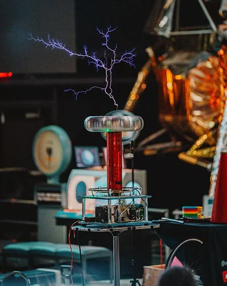 A large musical Tesla coil throwing purple lightning