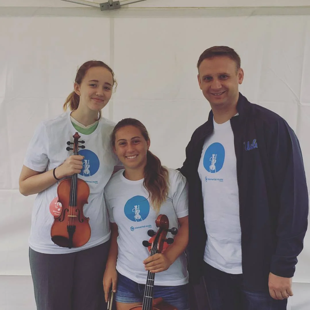 Elemental Music alumni volunteers at the Santa Monica COAST Festival with Elemental Strings Assistant Director Jason Aiello