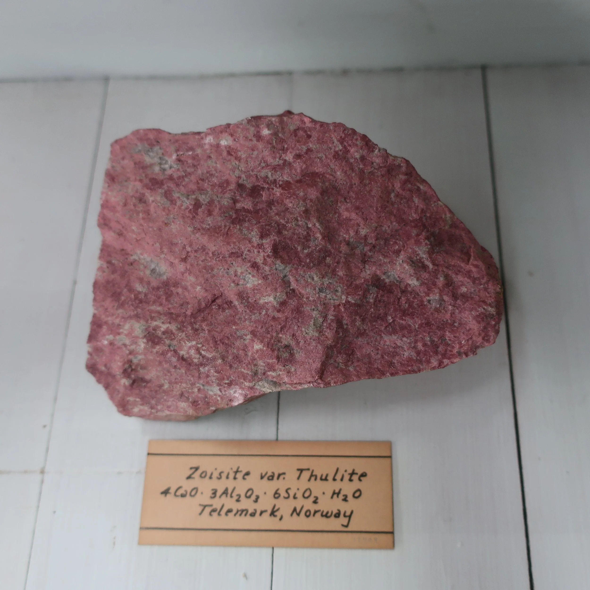 “Zoisite is composed of Silica 45. Alumina 29. Lime 21. Iron 3. Sp. Gr. 3.2. It occurs in oblique rhombic prisms, of a grey, greyish, yellow, or brown colour, but are rarely perfect, owing to deep longitudinal stria, the terminations are often incomplete. It also occurs massive, it is met with, in Styria, & Bavaria also at several places in our own country. This species is by Mohs, and others, united with epedote from which it principally differs in colour.”